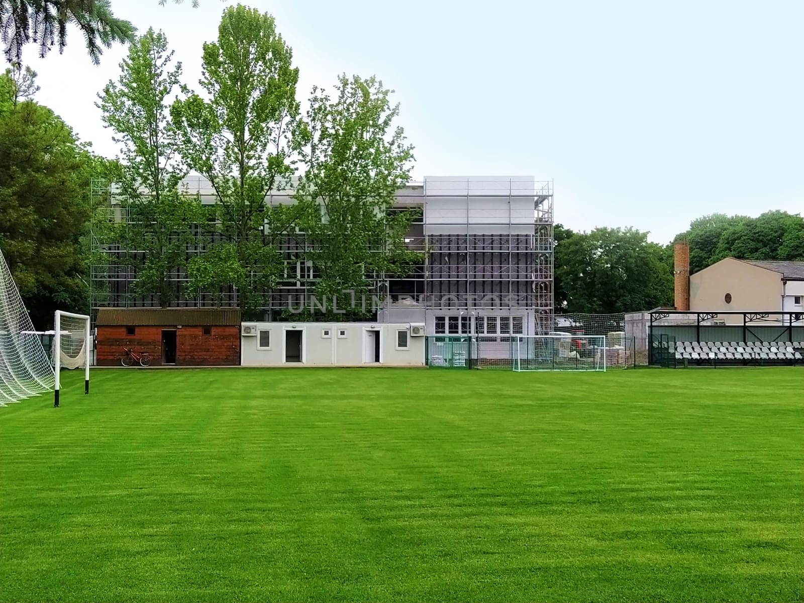 Sremska Mitrovica, Serbia. May 30, 2020. Construction of a new school. School building in scaffolding. Soccer field on the school grounds. Facade work at the final stage of construction.