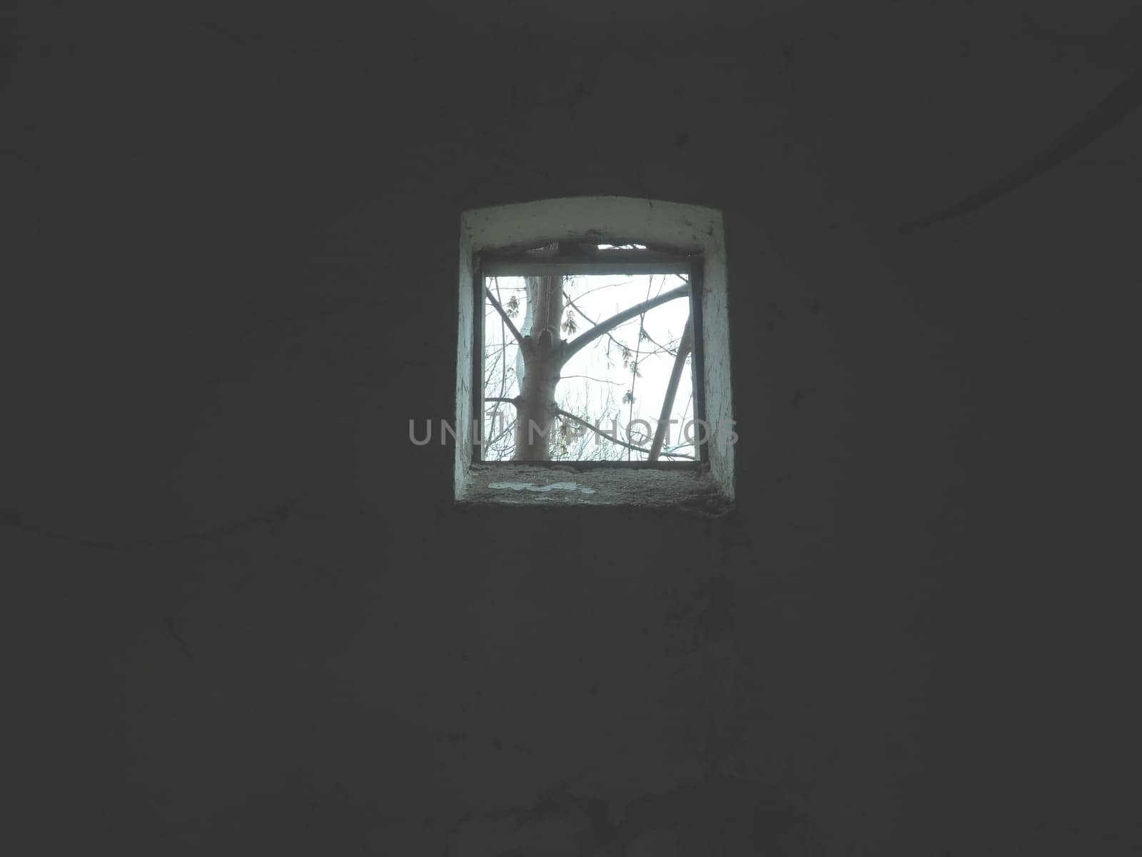 Scary walls with cobwebs. Old church dormer. A small window at the top of the wall. Halloween or haunted place. Prison cell with torture ropes. Visions and a world of hallucinations