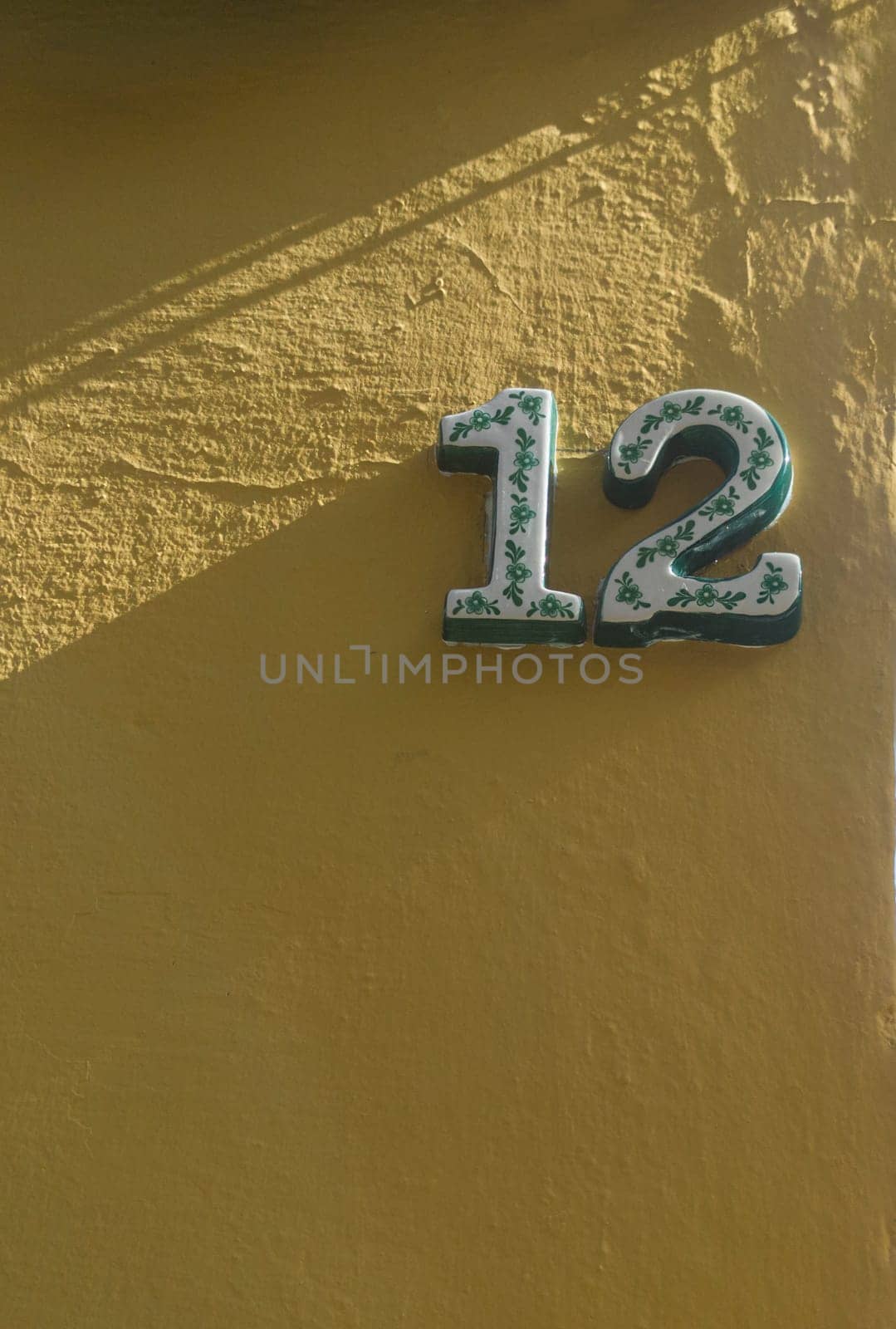 House number 12. Glazed decorated numbers. Houses with personality concept