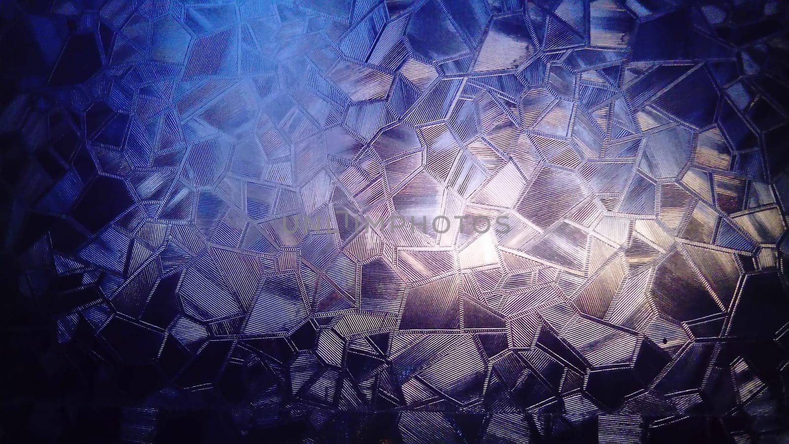 Light through the glass. Corrugated glass refracts the rays of the early morning sun. Winter frosty patterns. Violet, blue, pink colors and transitions from one to another color.