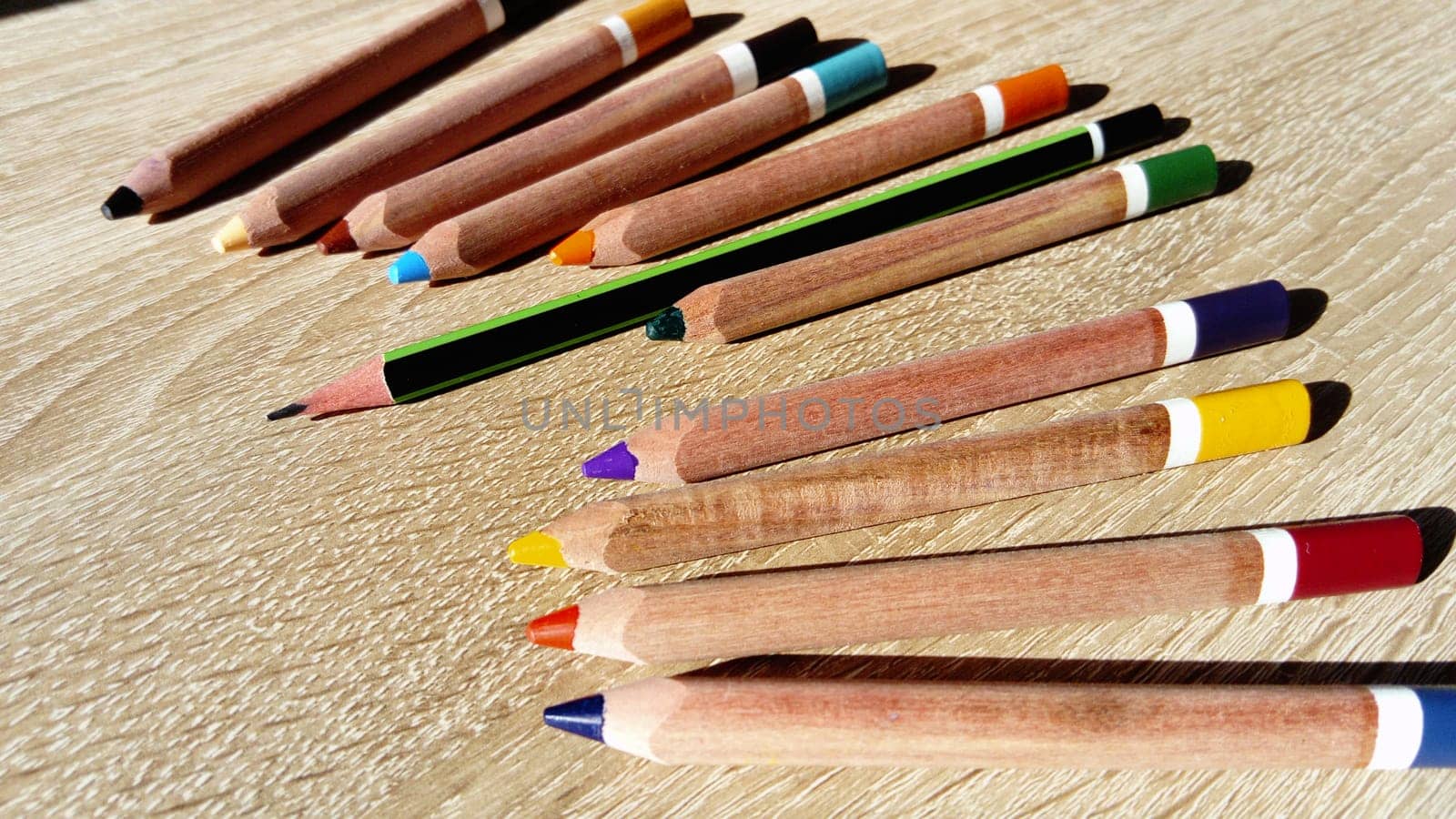 Multicolored wooden pencils for drawing. Pencils for working out the correct position of the pen in the fingers. Help first grader. The development of fine motor skills of the fingers