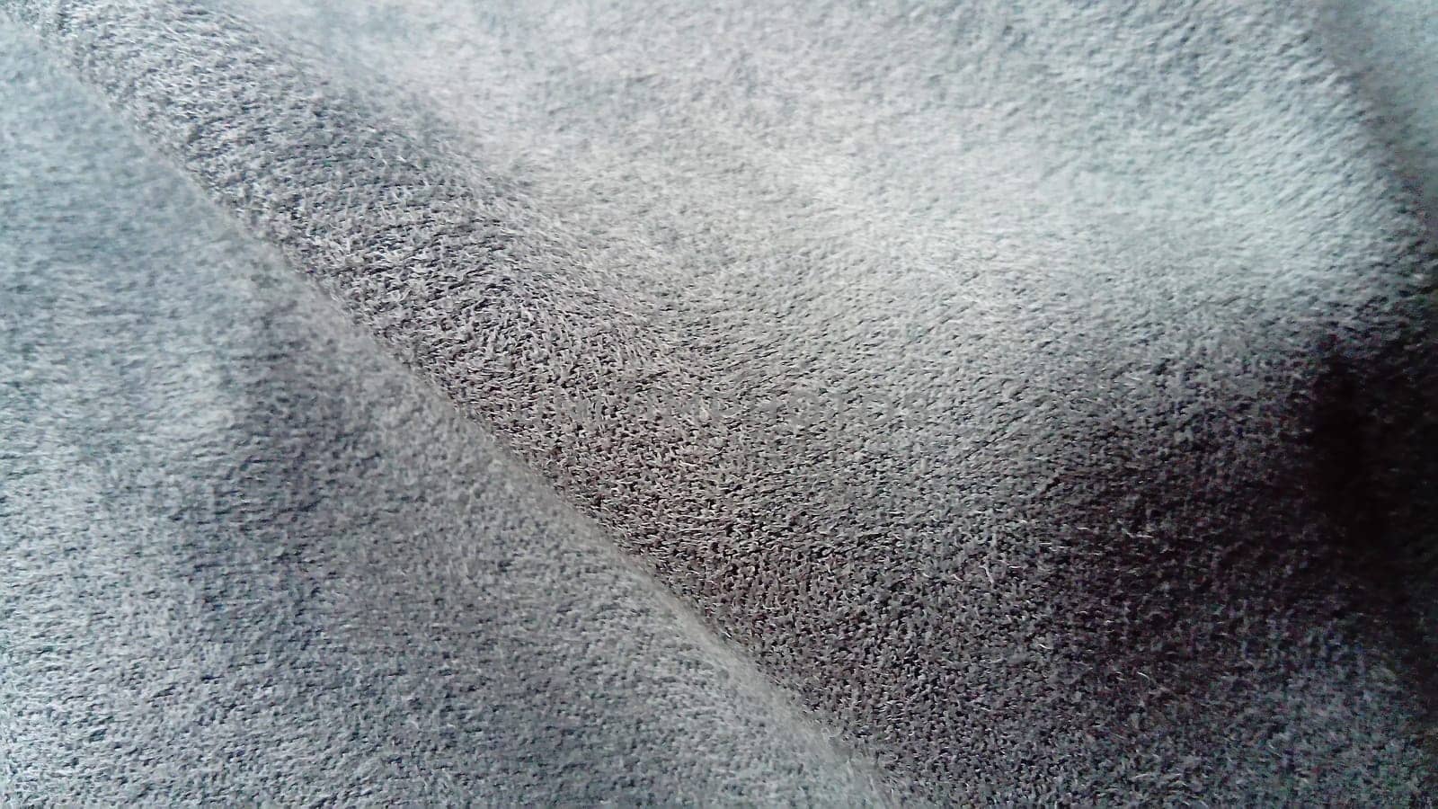 close-up of several waves on a soft velvety fabric of deep gray color