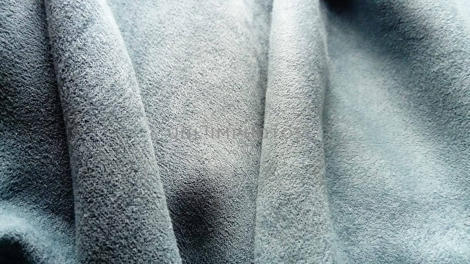 close-up of velvety thick fabric for curtains of gray-blue color