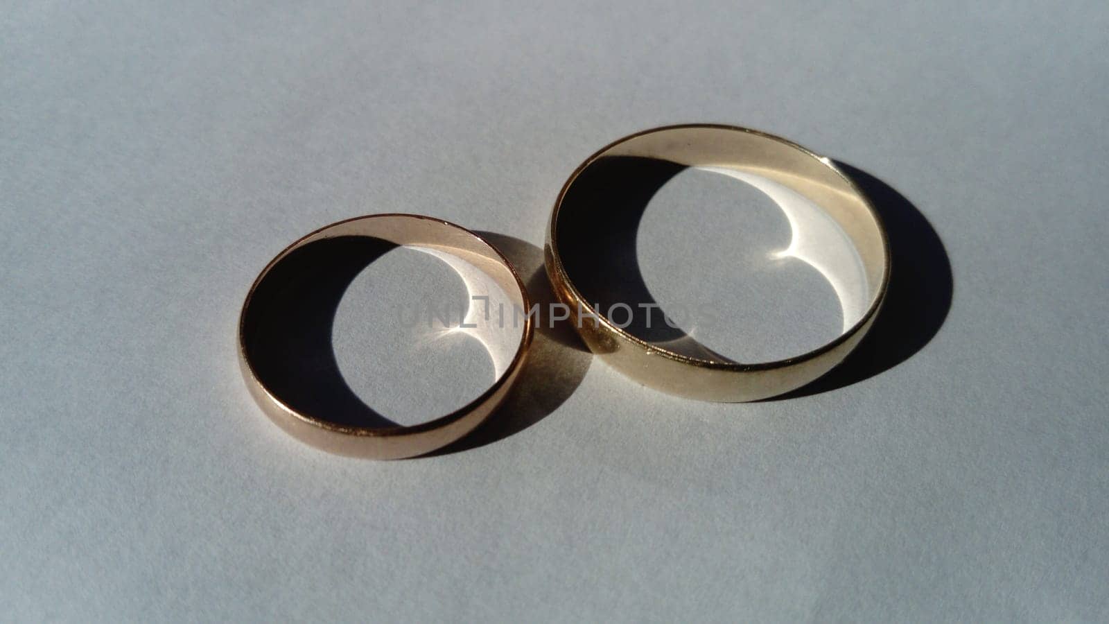 two wedding gold rings on a white background