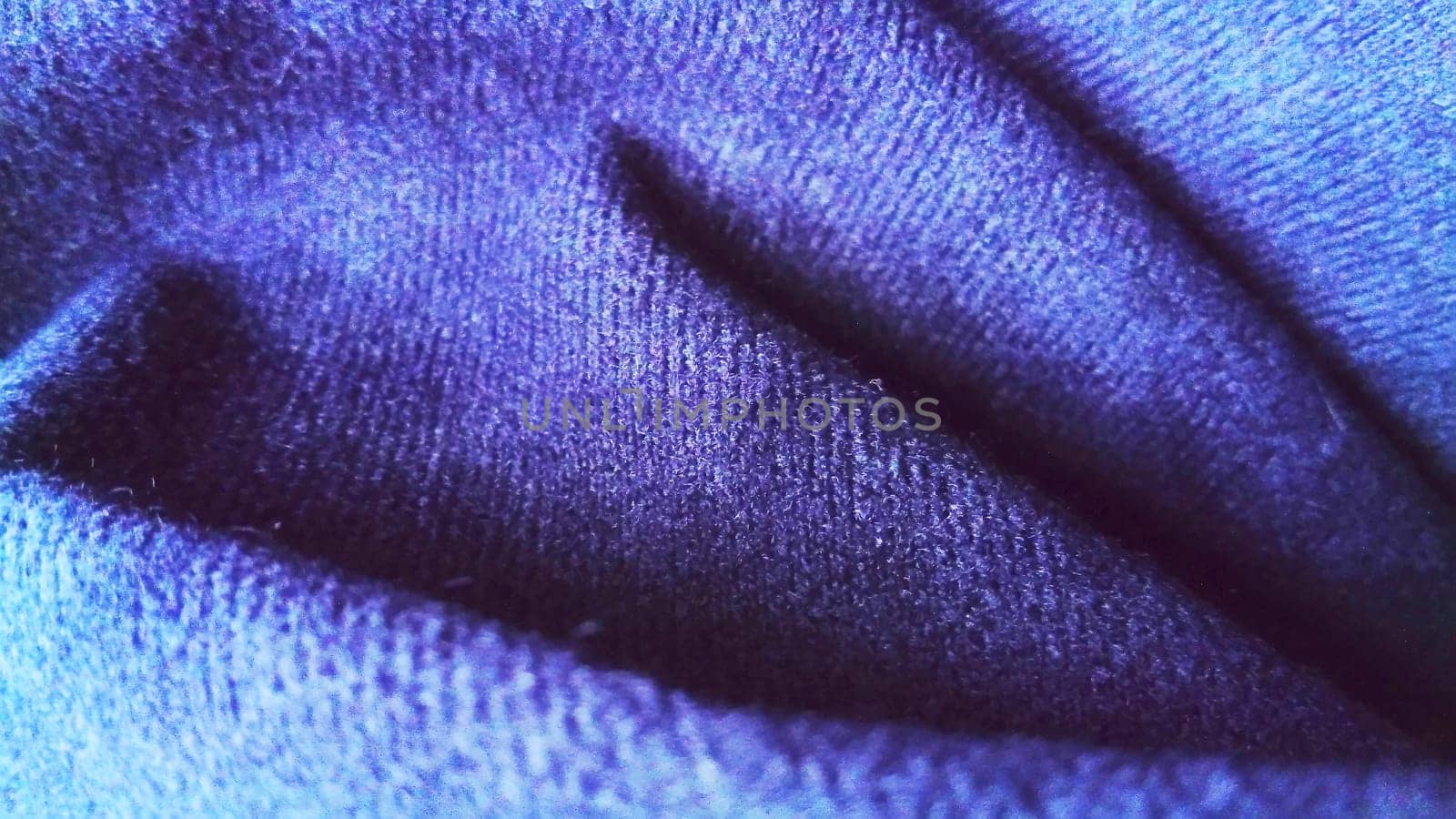 Dark blue fabric that looks like velvet or velveteen. Broken waves. Blue. Violet. The black