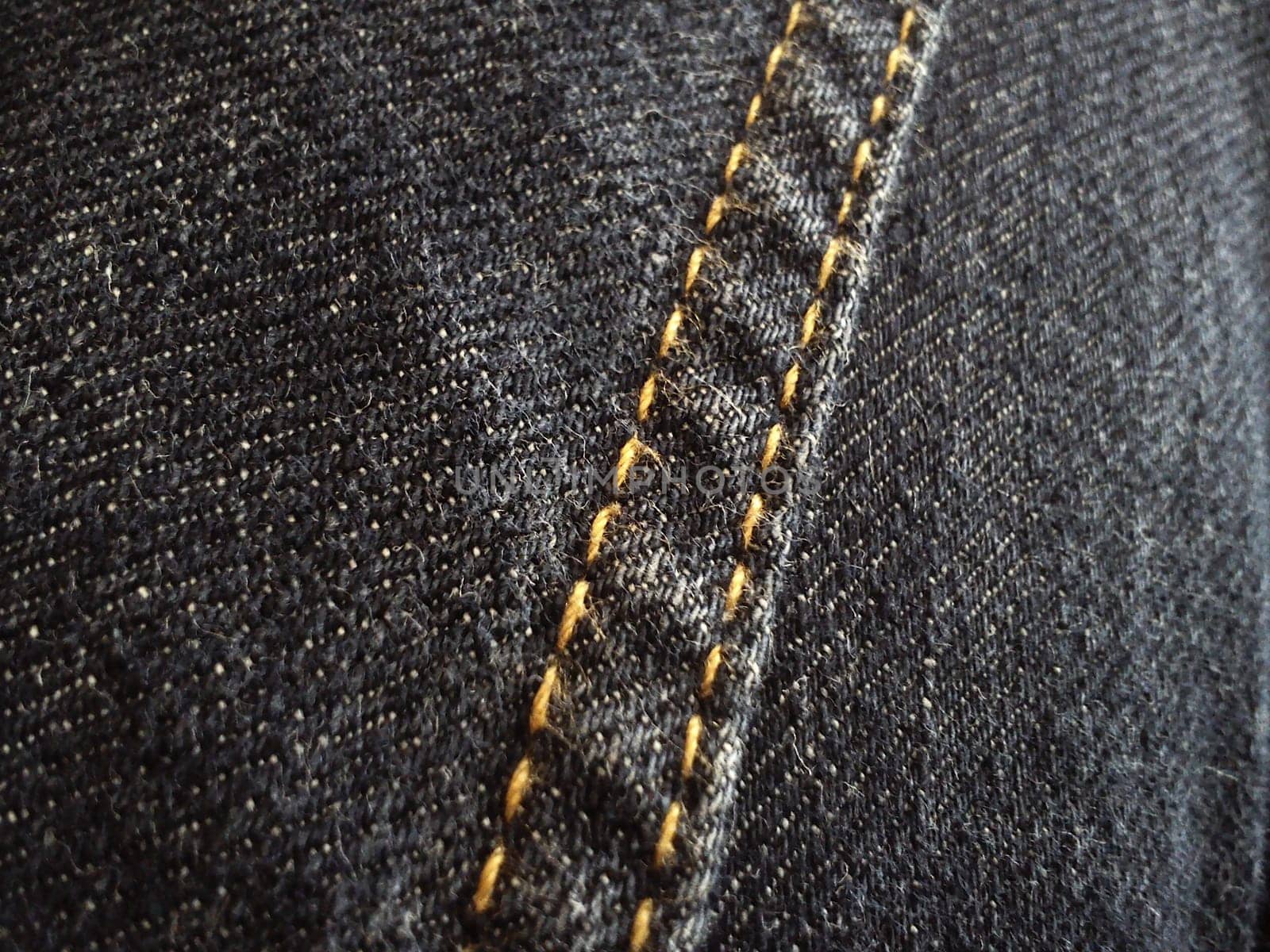 double stitch made with yellow threads on black denim.