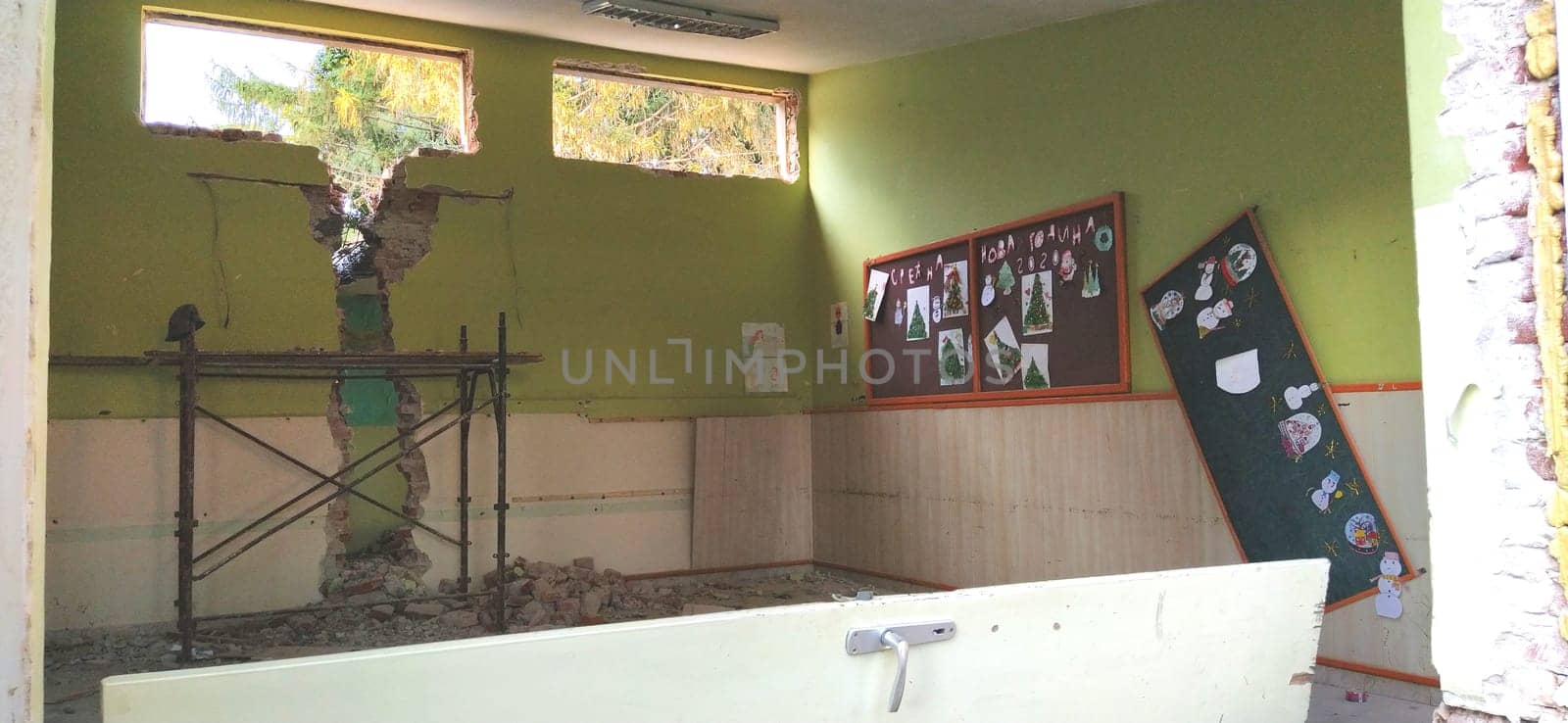 Sremska Mitrovica, Serbia, 13 August 2020. Dismantling and demolition of the old school named after Jovan Popovic. Holes in the walls and ceiling. Ruined classroom.
