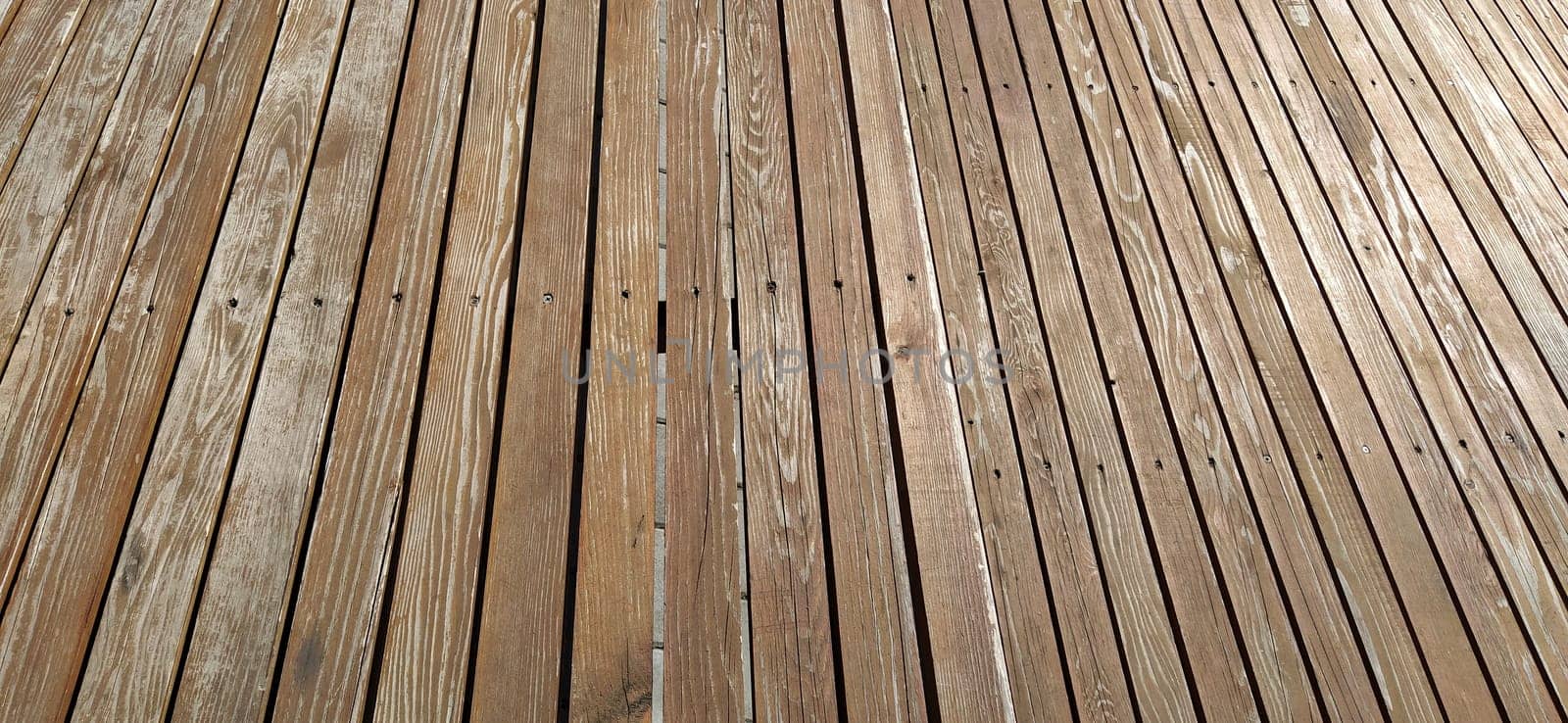 Beautiful smooth unpainted hammered boards. Wooden surface with cracks. A platform or staircase made of wood. Joiner's and carpentry product. The texture of natural material