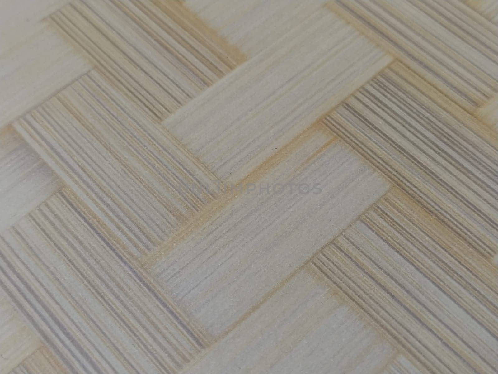 Fragment of parquet floor. Parquet pattern. Interlacing of elements. Wooden, bamboo or thatch surface. Hot mat. Close-up