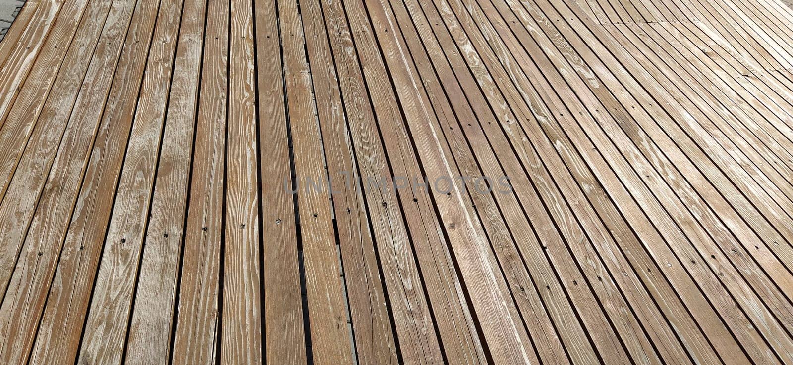 Beautiful smooth unpainted hammered boards. Wooden surface with cracks. A platform or staircase made of wood. Joiner's and carpentry product. The texture of natural material