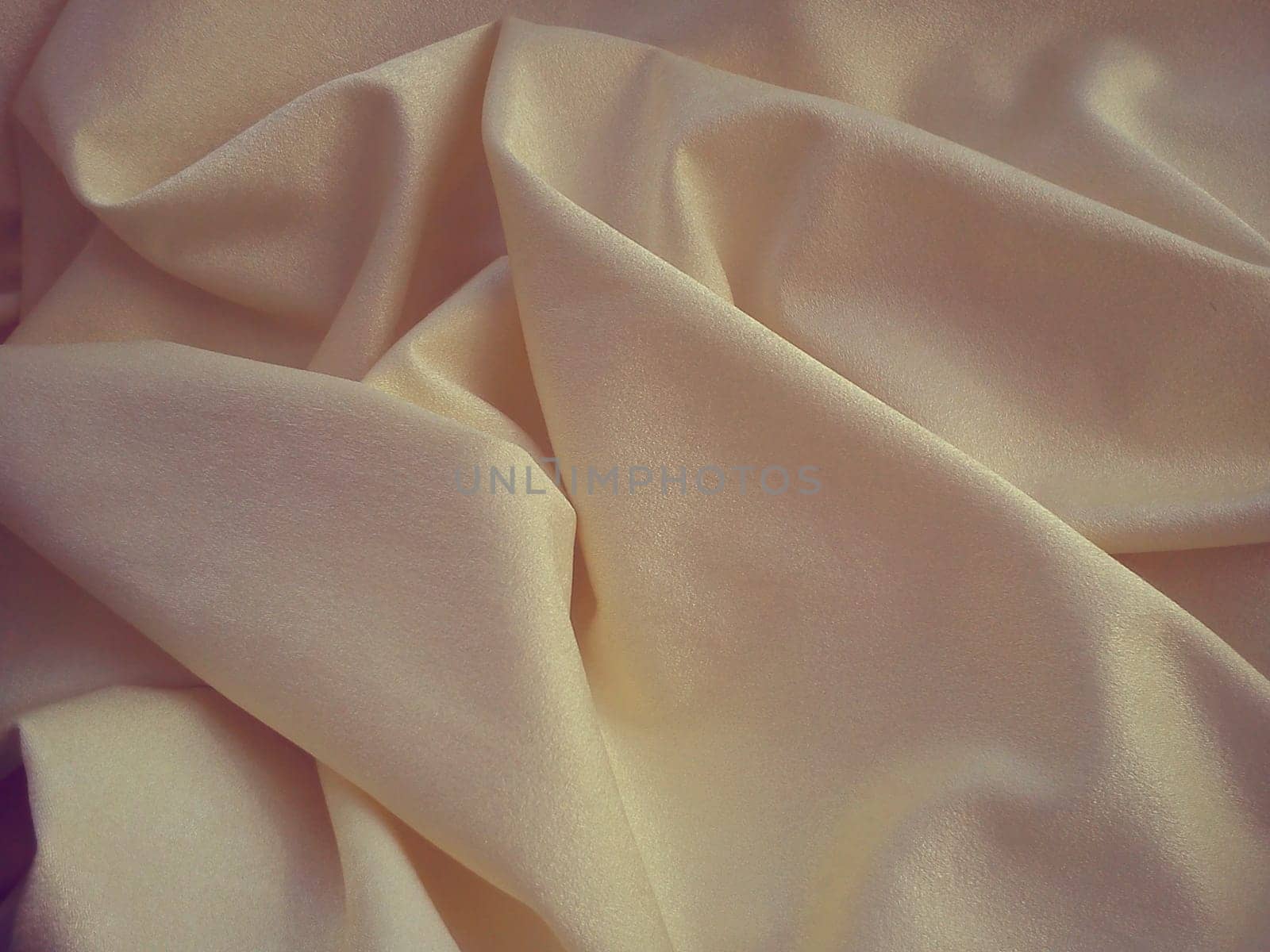Beautiful velvet yellow-pink curtains. Light negligence when folding the material. Soft, soft-touch curtains for the room or kitchen. Fabric for sewing clothes.
