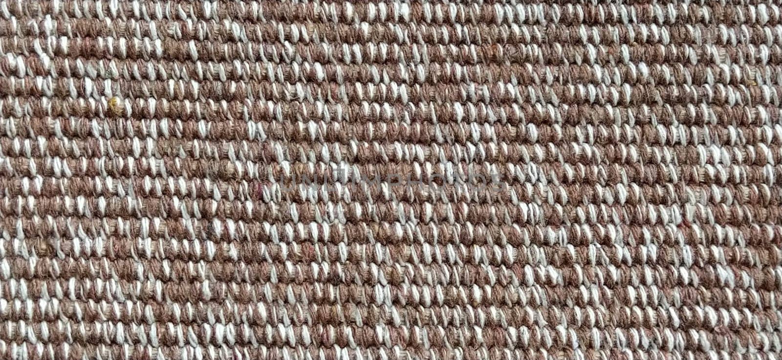 close up of fabric texture for background. Woven coarse cotton fabric with white, beige and brown threads. Banner.