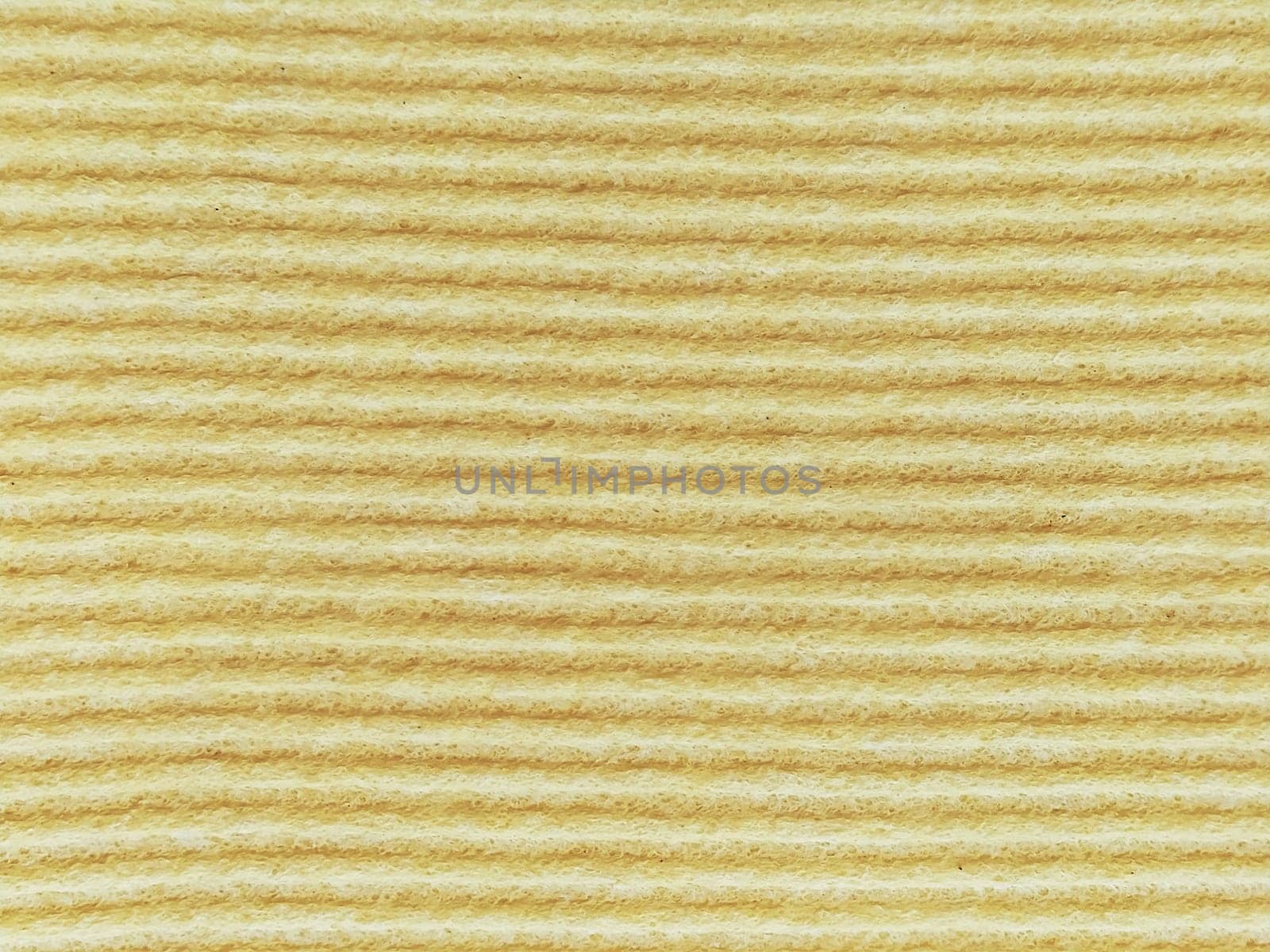 Close-up of a striped fabric with raised printing. Horizontal stripes on yellow microfiber or sponge