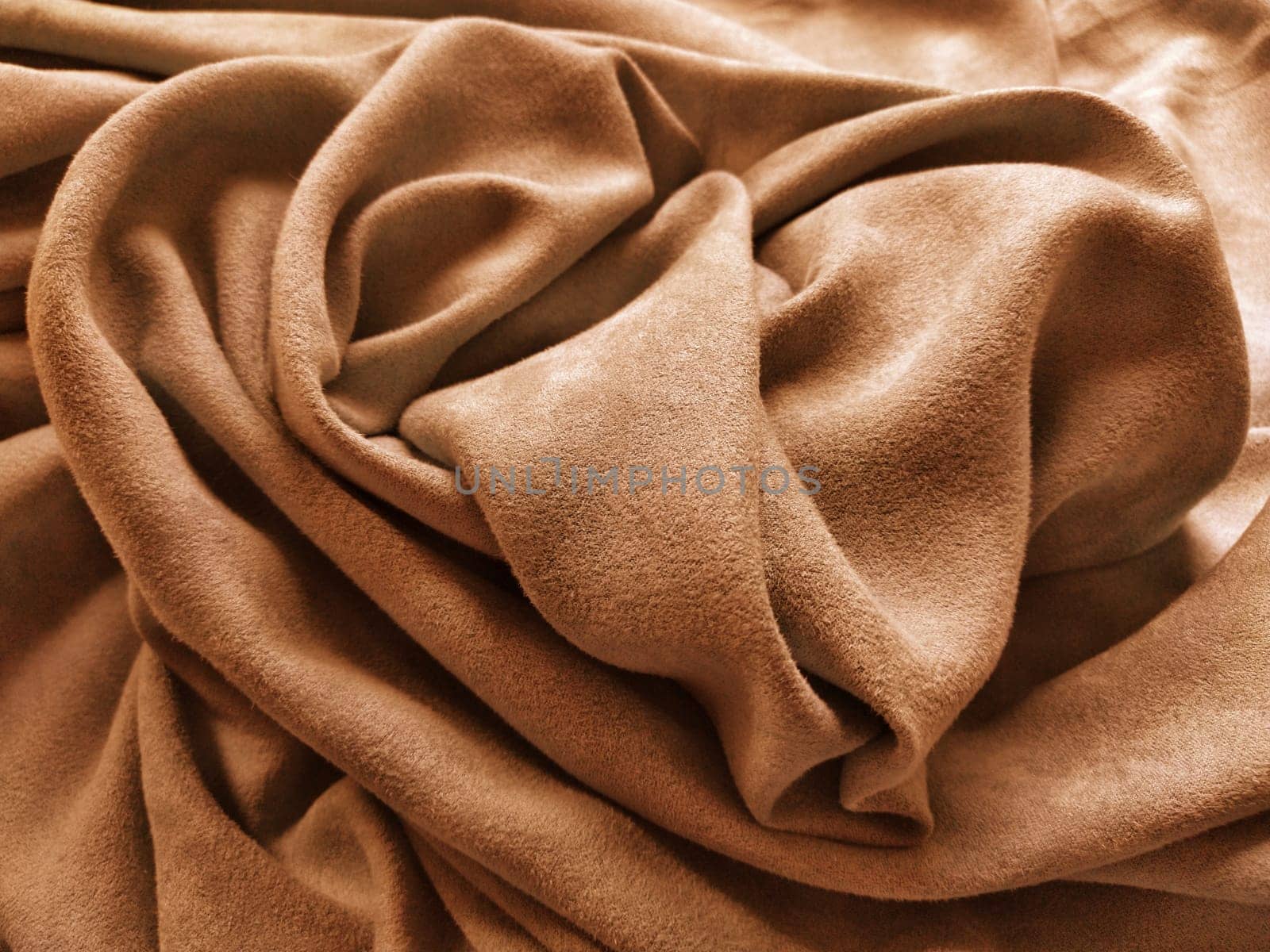 Fabric for curtains and curtains. Beautiful brown - terracotta color. Soft velvet with velvet. The curtain material is carelessly folded on a horizontal surface. Fabric sample. Interior Design Option.