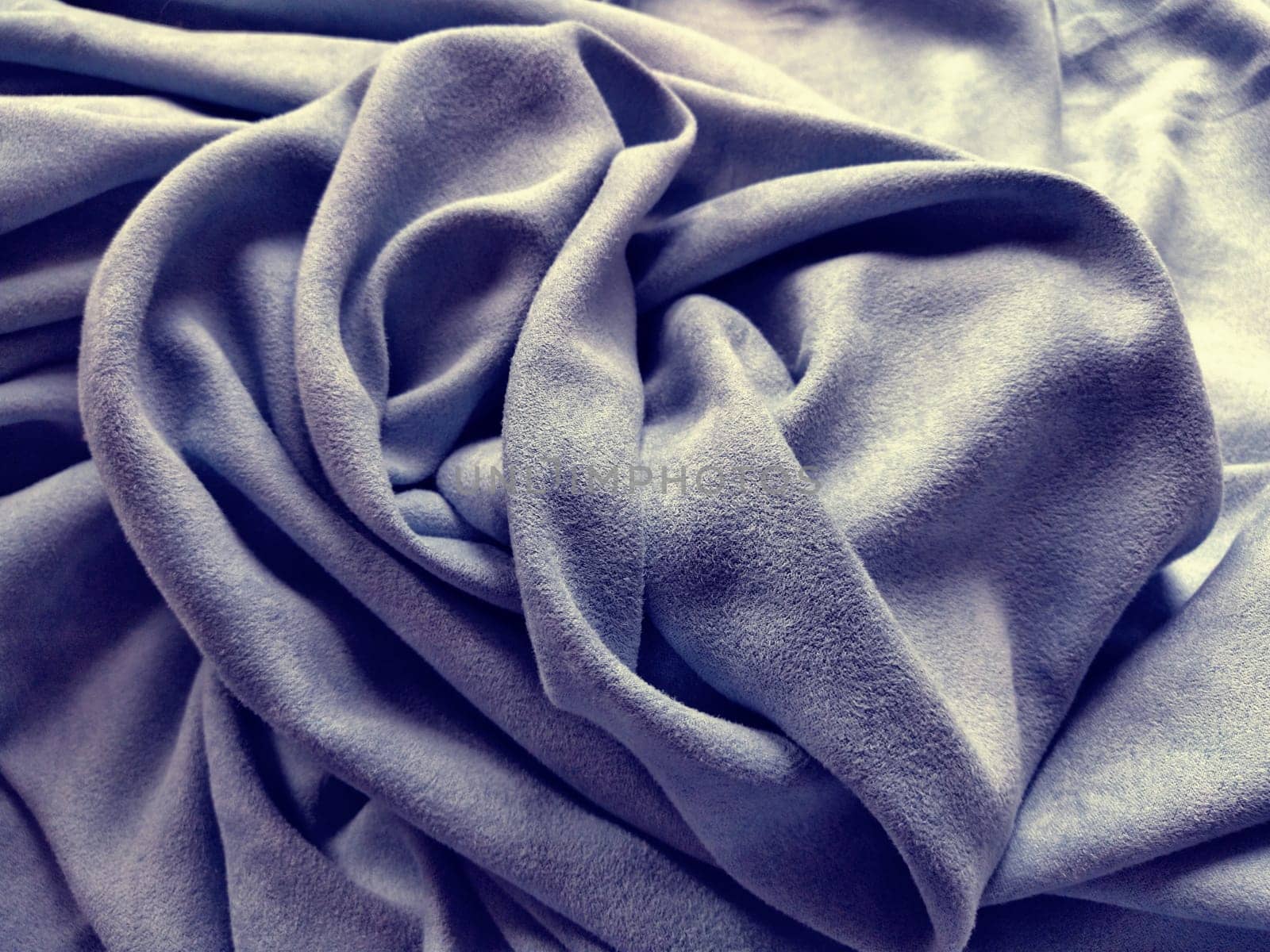 Fabric for curtains and curtains. Beautiful gray purple. Soft velvet with velvet. The curtain material is carelessly folded on a horizontal surface. Fabric sample. Interior Design Option