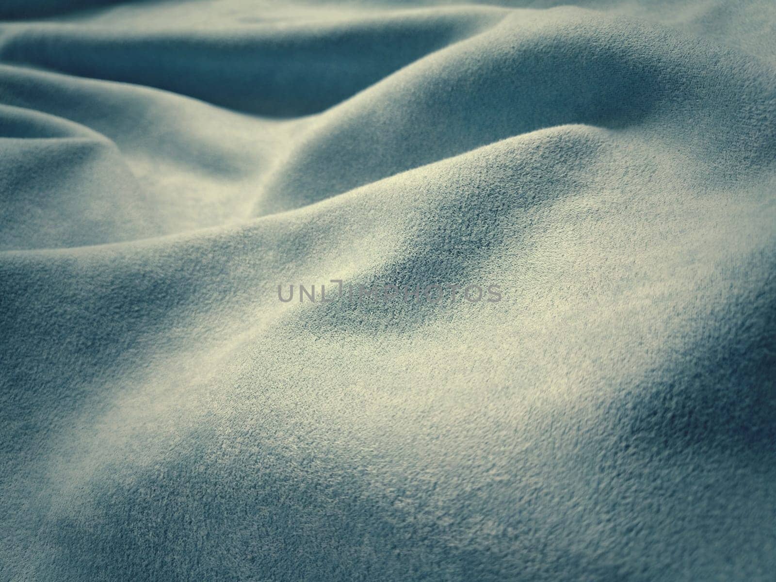 Fabric sheer curtain fabric. Beautiful blue color. Soft velvet with a pile. The curtain material is carelessly folded and wrinkled on a horizontal surface. Fabric sample. Interior design option