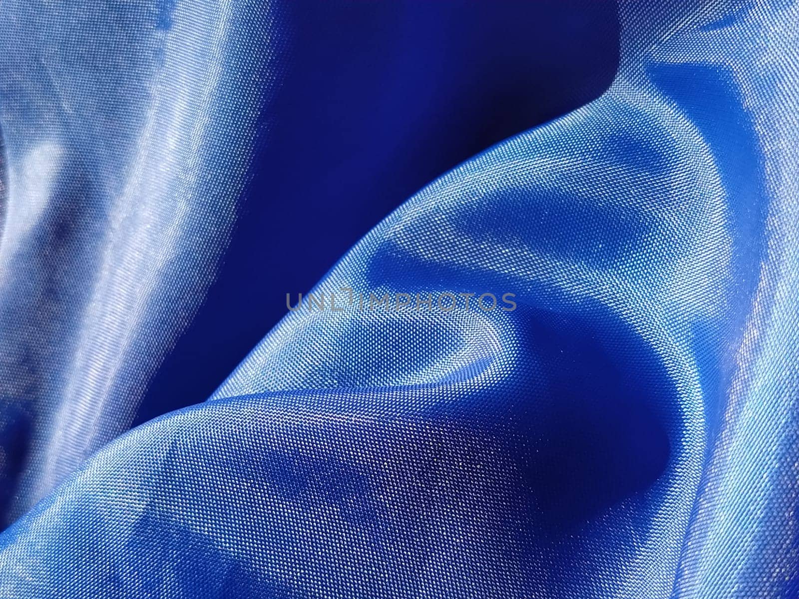 Blue silk lining. Close-up. A piece of fabric on curtains or a raincoat.