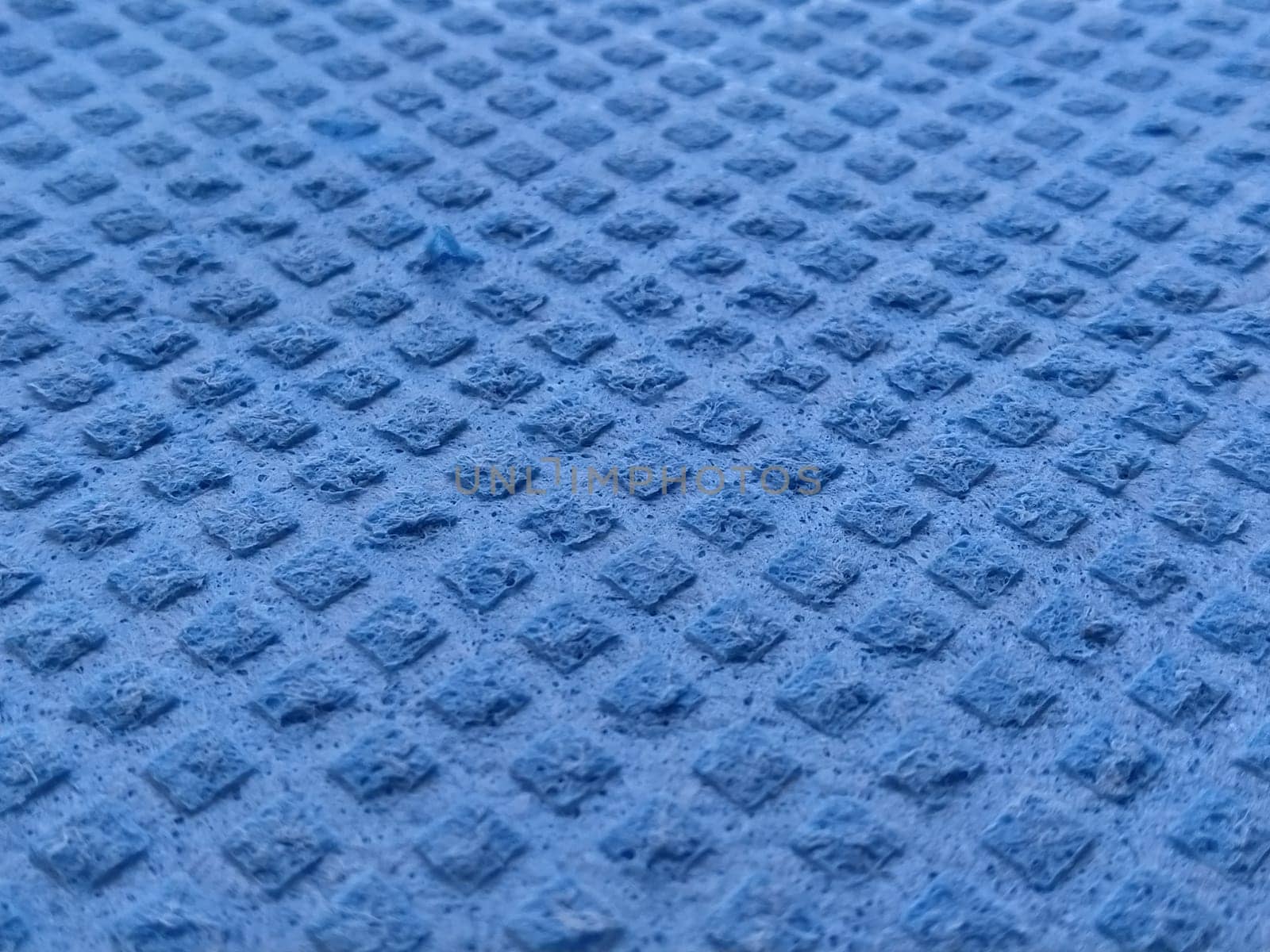 Dishwashing sponge background. close-up of blue dishwashing sponge. Soft focus.