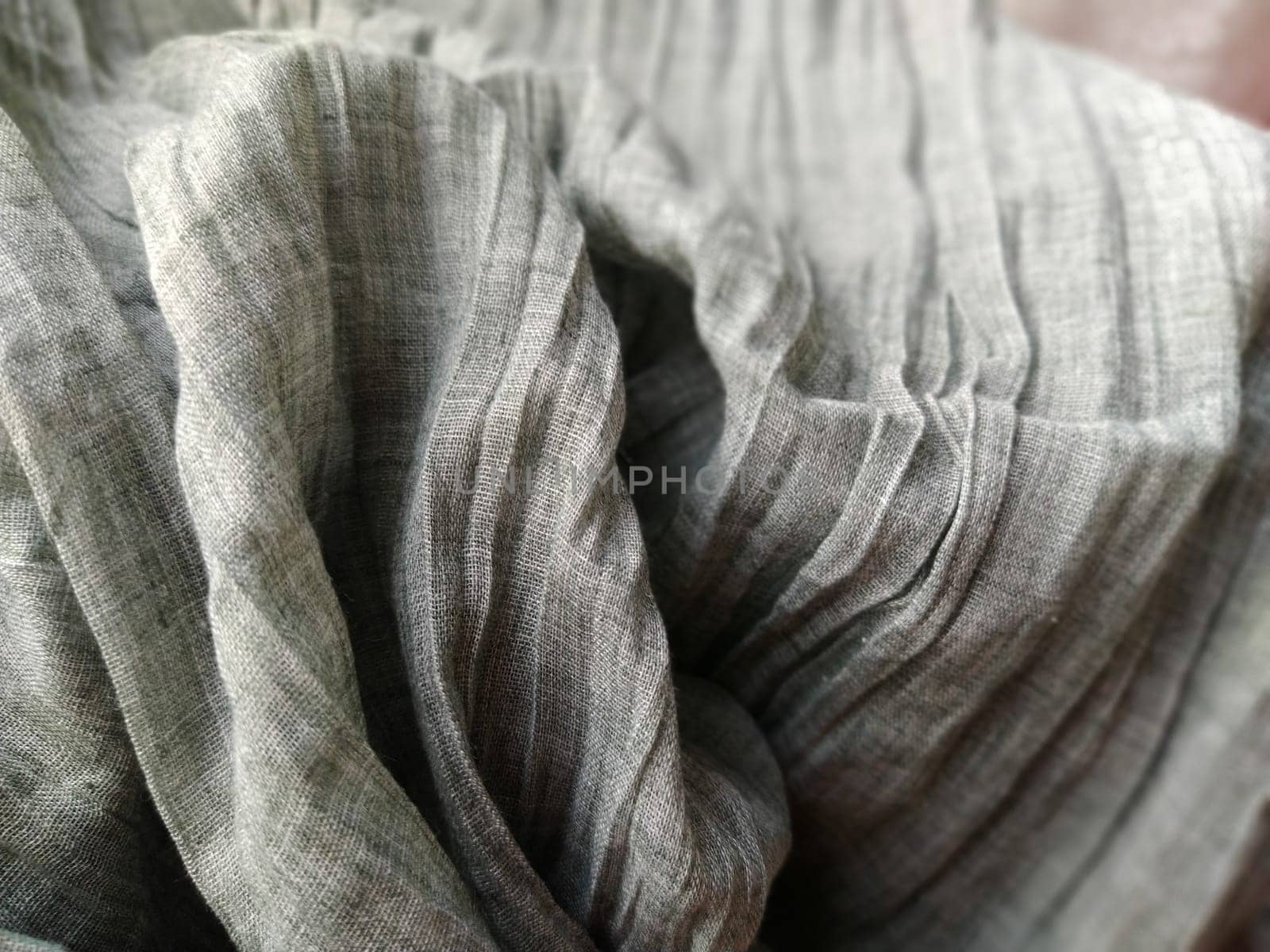 Fabric sheer curtain fabric. Beautiful gray color. The curtain material is carelessly folded and wrinkled. Fabric sample. Interior design option.