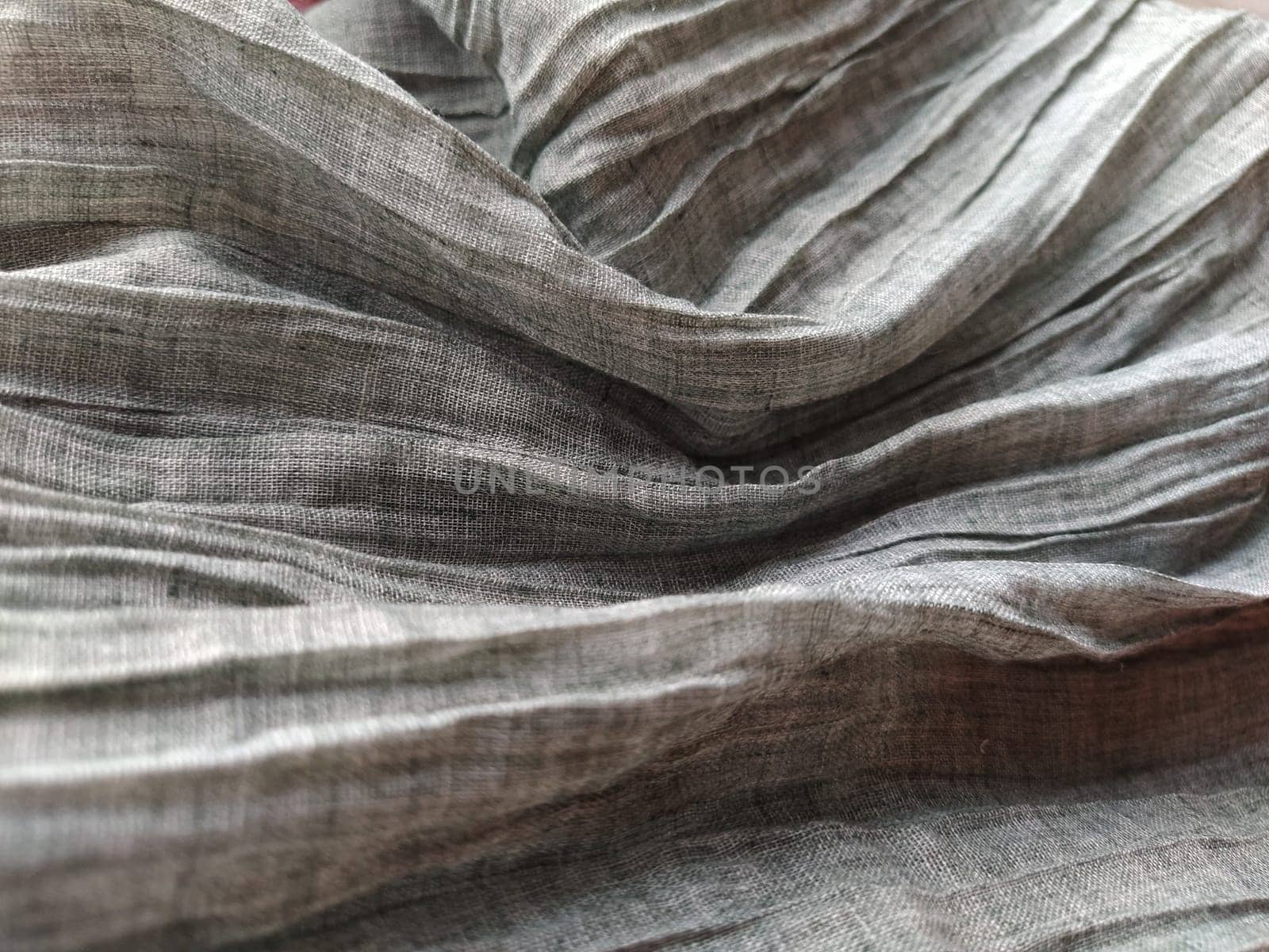 Fabric sheer curtain fabric. Beautiful gray color. The curtain material is carelessly folded and wrinkled. Fabric sample. Interior design option.