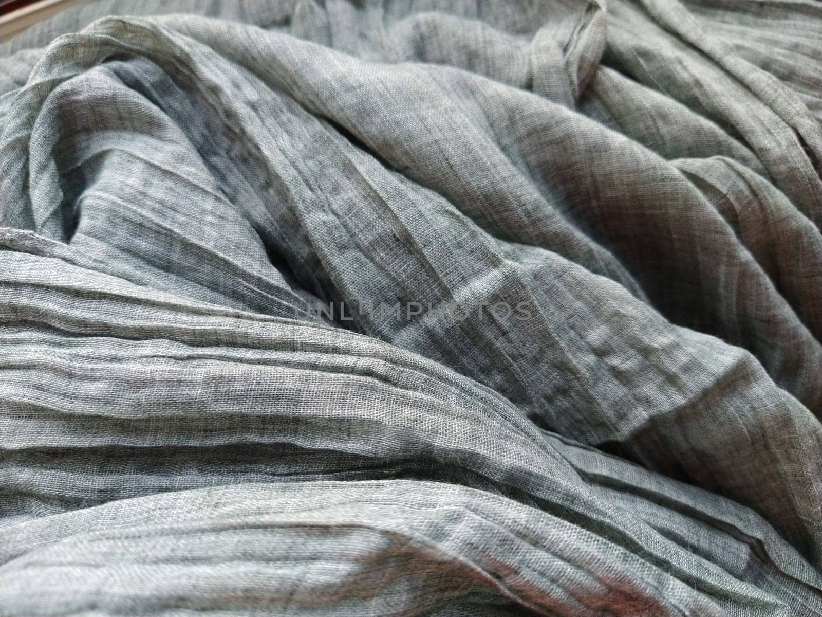 Fabric sheer curtain fabric. Beautiful gray color. The curtain material is carelessly folded and wrinkled. Fabric sample. Interior design option.