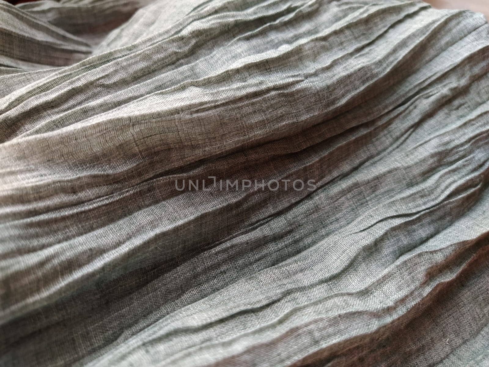 Fabric sheer curtain fabric. Beautiful gray color. The curtain material is carelessly folded and wrinkled. Fabric sample. Interior design option.