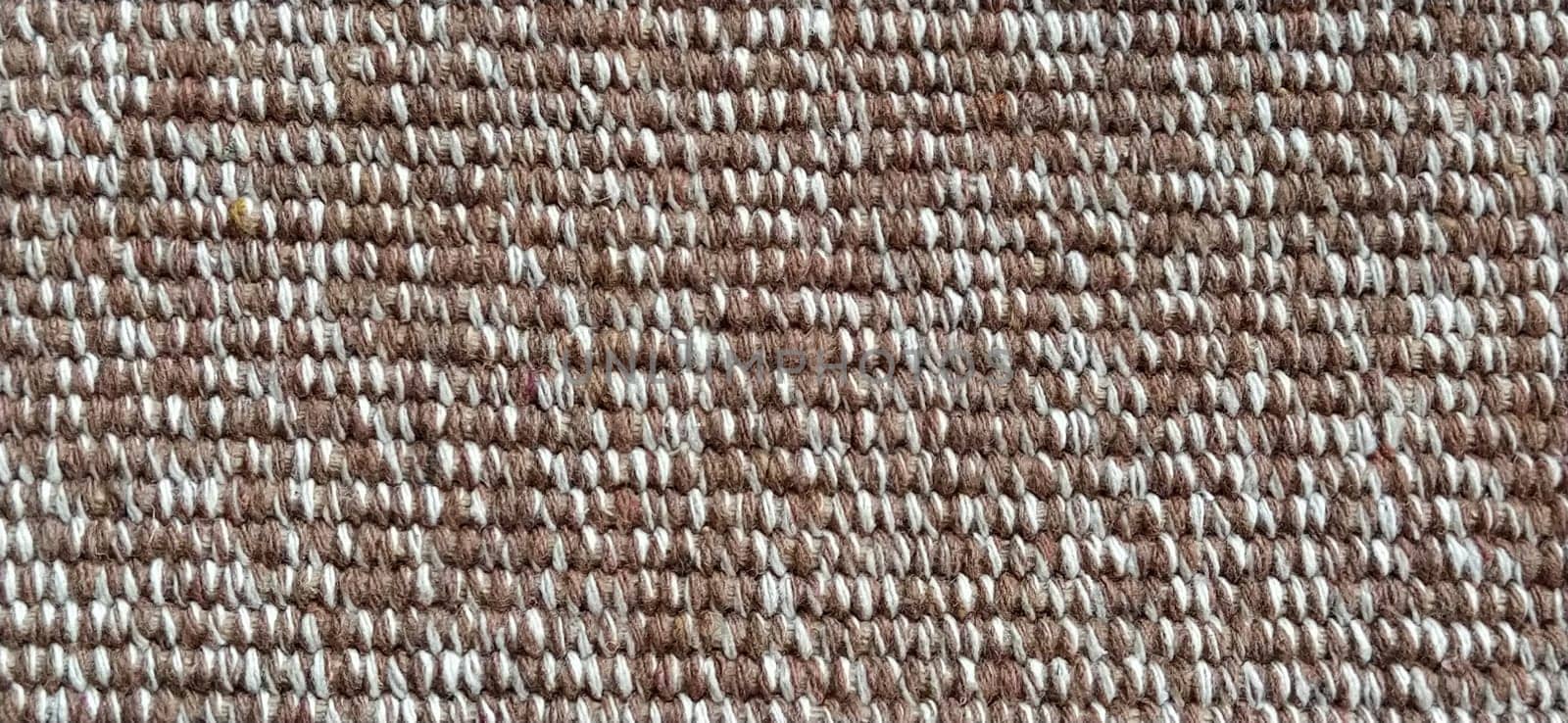 close up of fabric texture for background. Woven coarse cotton fabric with white, beige and brown threads. Banner