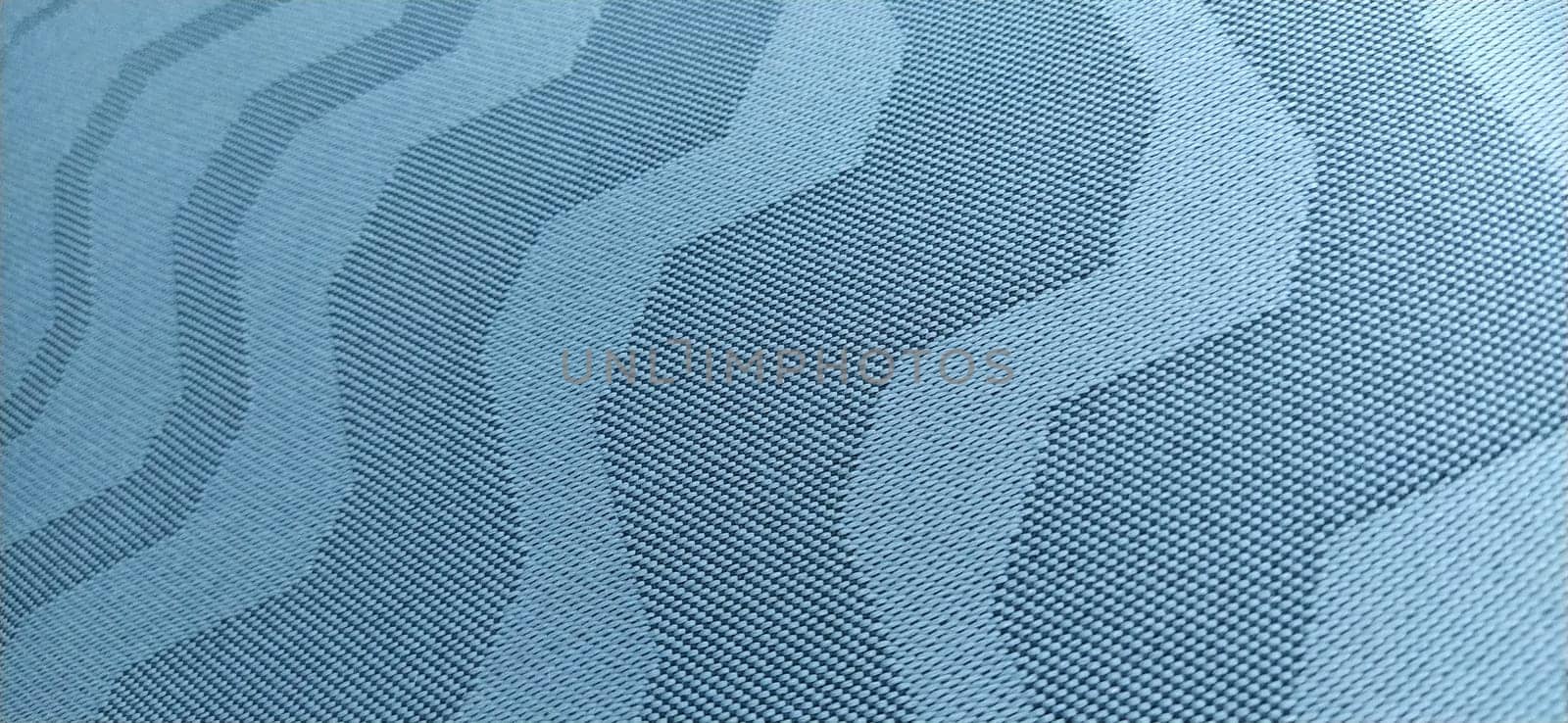 abstract curves on a gray background. Fabric texture. Wide lines and winding stripes.