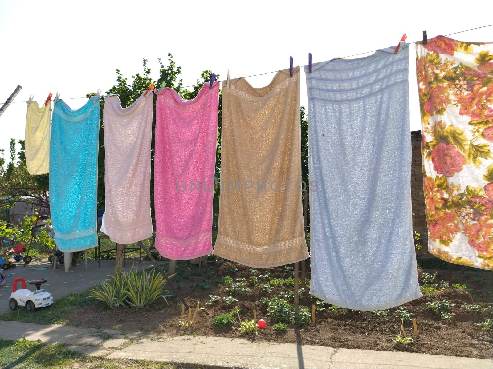 Sremska Mitrovica, Serbia July 10, 2020, towels and clothes dry on a rope. Housewife worries. The wet cloth is hung on clothespins for further drying. big washing.
