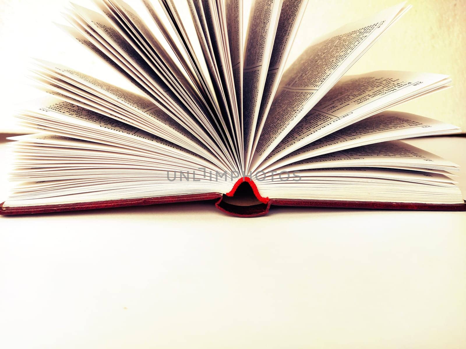 the opened book on the white table.