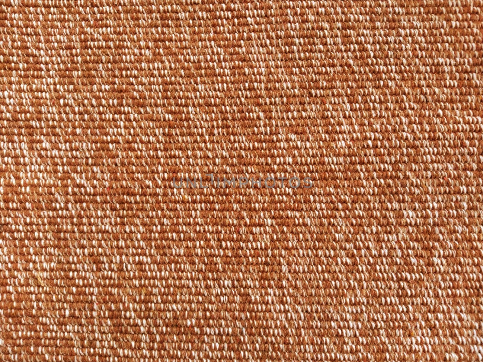 Wicker warm plaid close-up. The threads are brown, red and orange. Fabric or knit texture