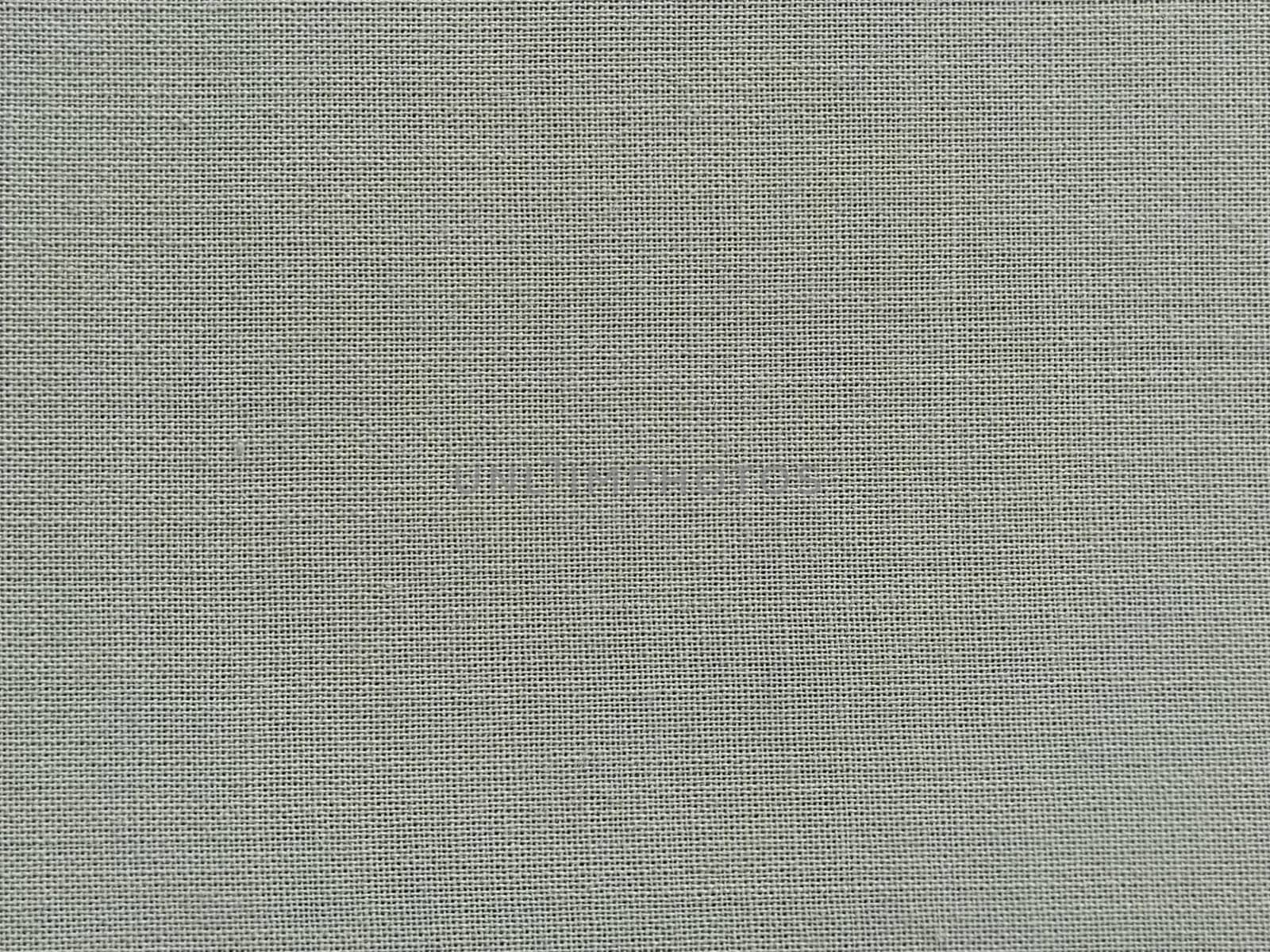 pale light green fabric. A piece of woolen fabric laid out neatly on the surface. Interlacing and textile texture. dress fabric or for kitchen needs, tablecloth or curtains, Close-up.