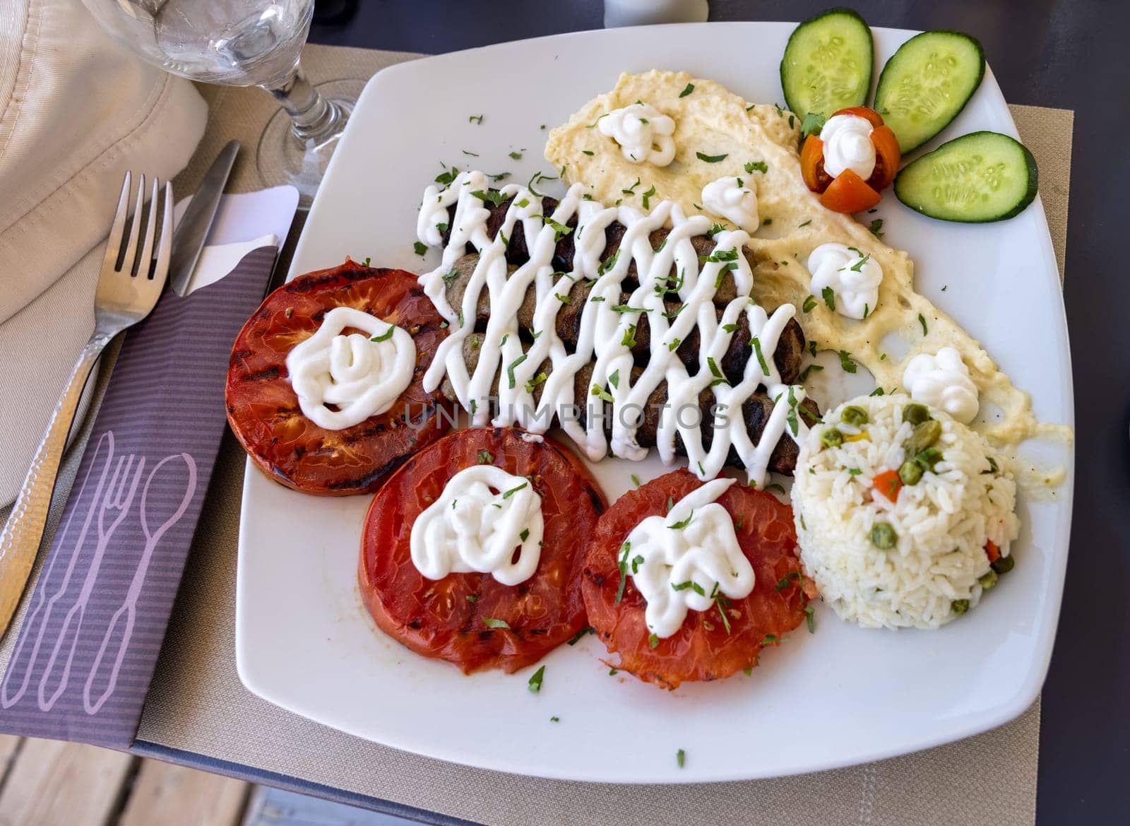 Fried souvlaki and grilled tomatoes.