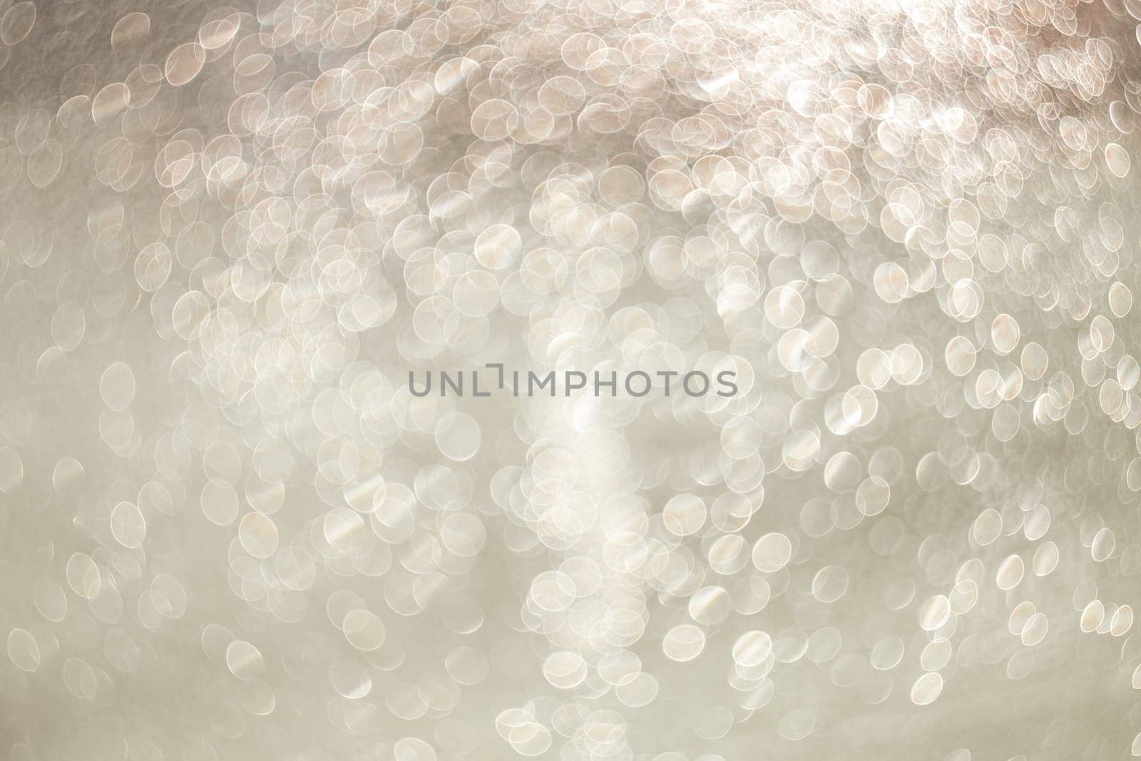 Creative background image. Light transparent drops of water in blur. Blurred bokeh on light background.