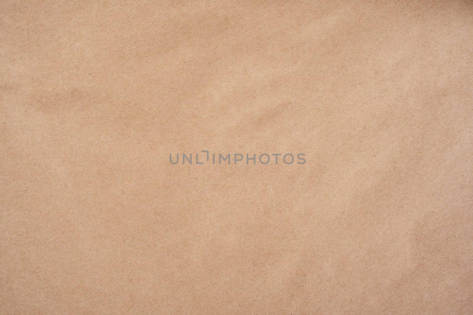 Background image of rough crumpled recycled textured kraft paper. Top view. Copy space