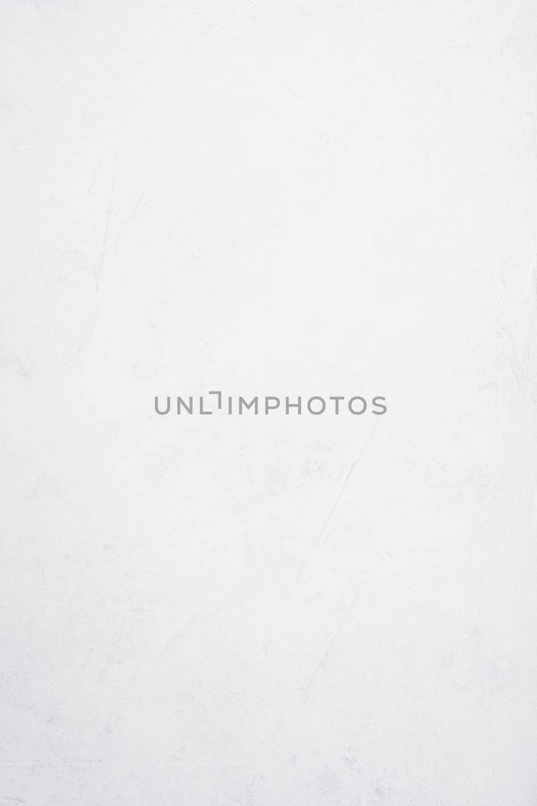 Background image of white uneven concrete surface. Top view. Copy space. Vertical