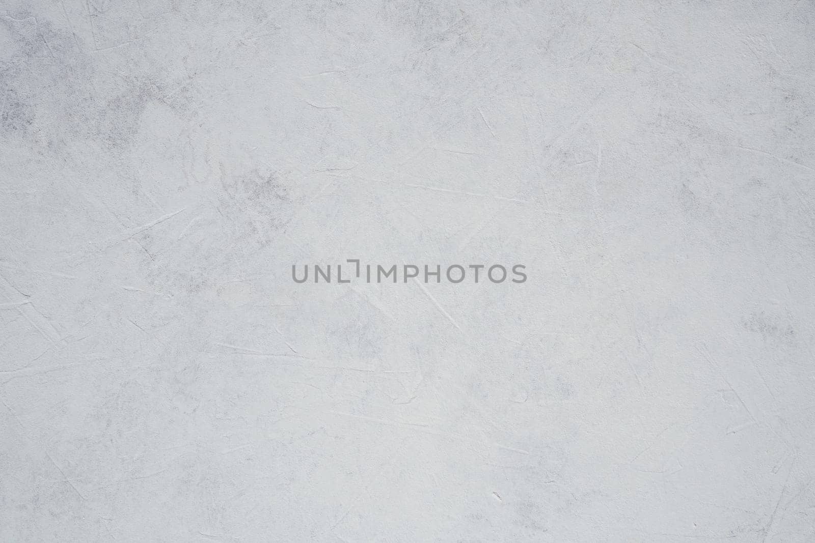Background image of white uneven concrete surface. Top view. Copy space