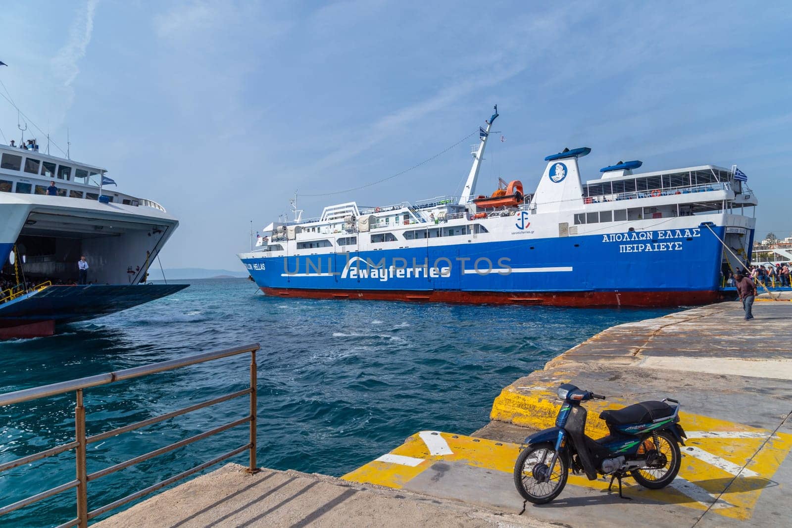 Pireas Greece: May 07 2022: Ferry boats cruise ships docking at the port of Piraeus Greece. The port of Piraeus is the largest passenger port in Europe and the third largest in the world.
