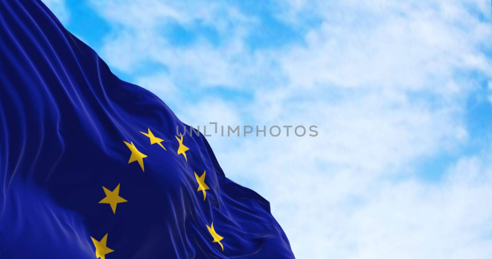 The flag of the European Union Waving on a clear day. Twelve yellow stars on a blue background. The stars symbolize the unity of the European peoples. 3d illustration render. Rippled textile