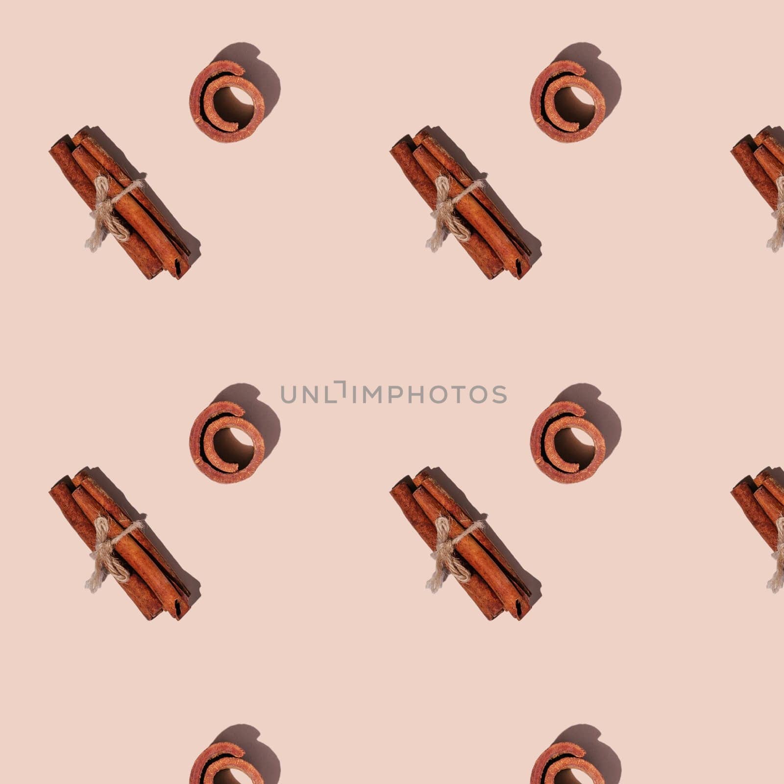 Seamless endless pattern of cinnamon with hard shadows isolated on light pink background. Top view