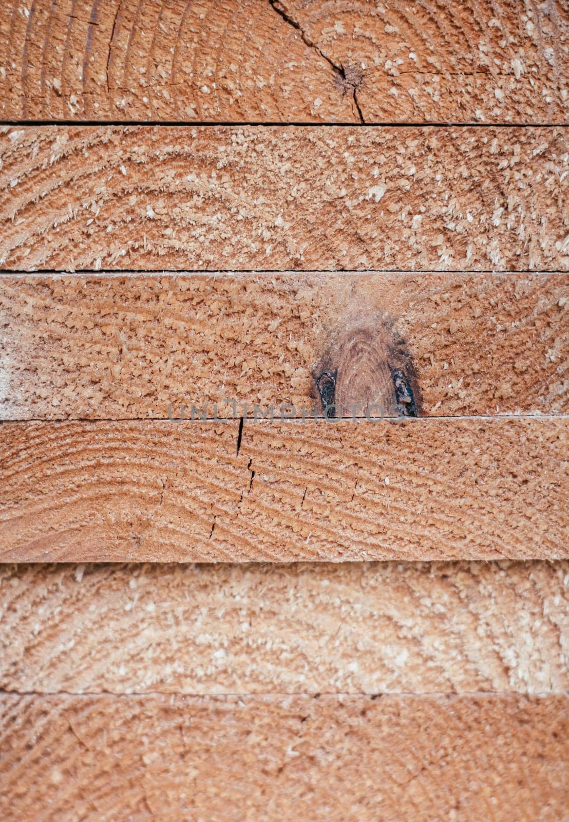 Background texture. Ends of stacked edged boards. Top view. Copy space. Vertical