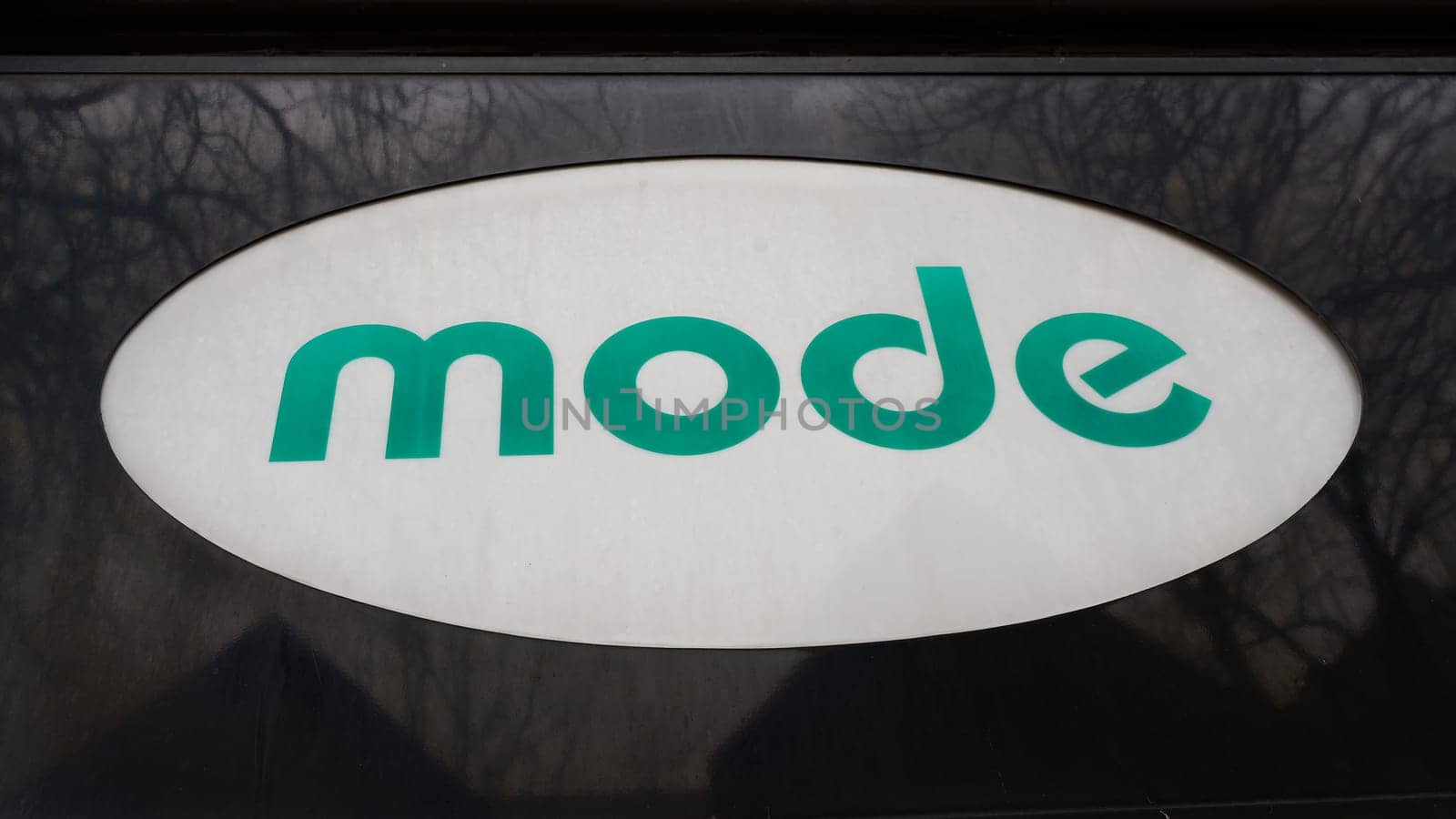 Neon sign with german lettering mode on a german fashion store. Translation: Fashion