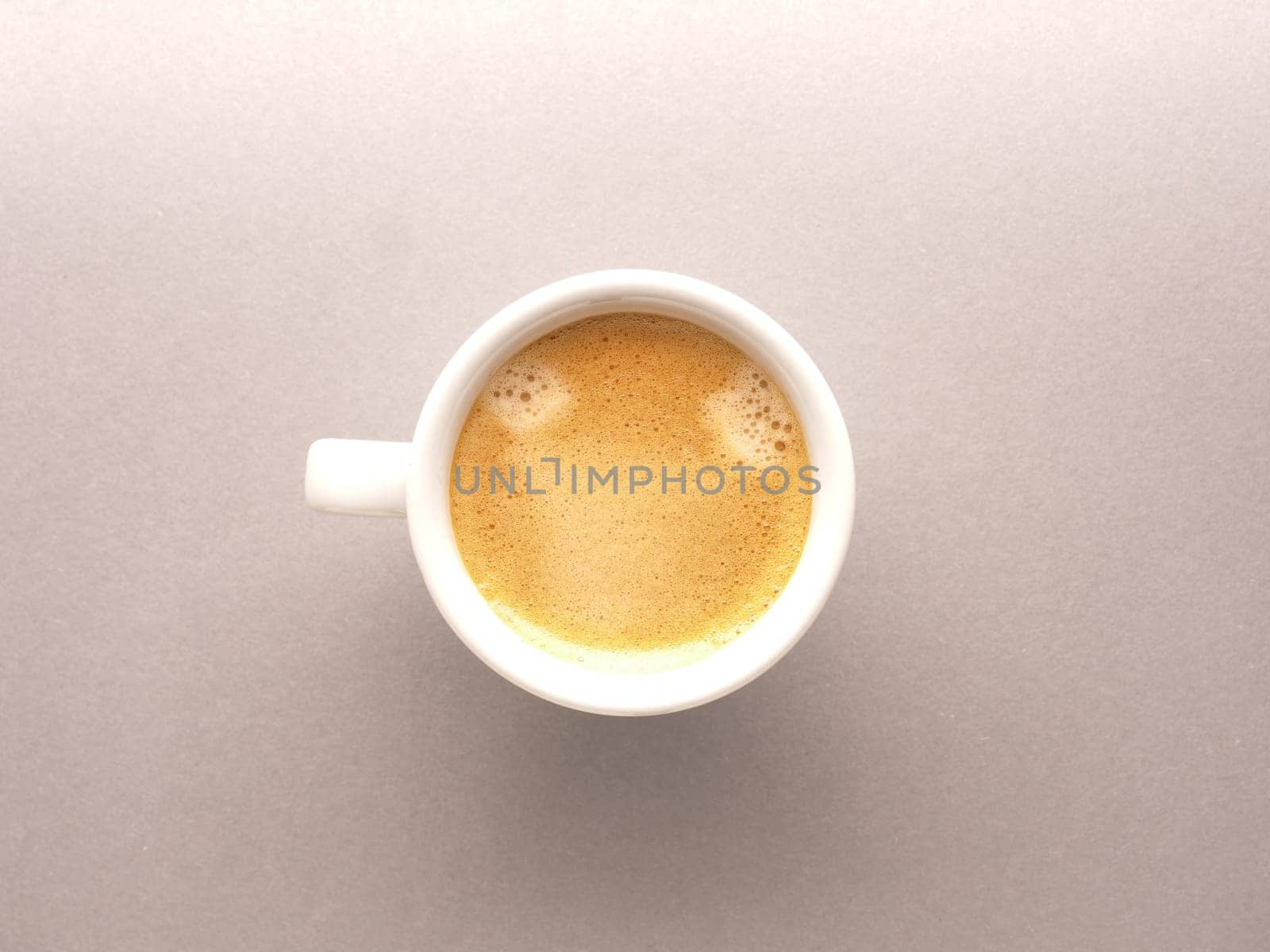 White espresso cup with a delicious smelling organic espresso, view from above, tasty food, daily beverage