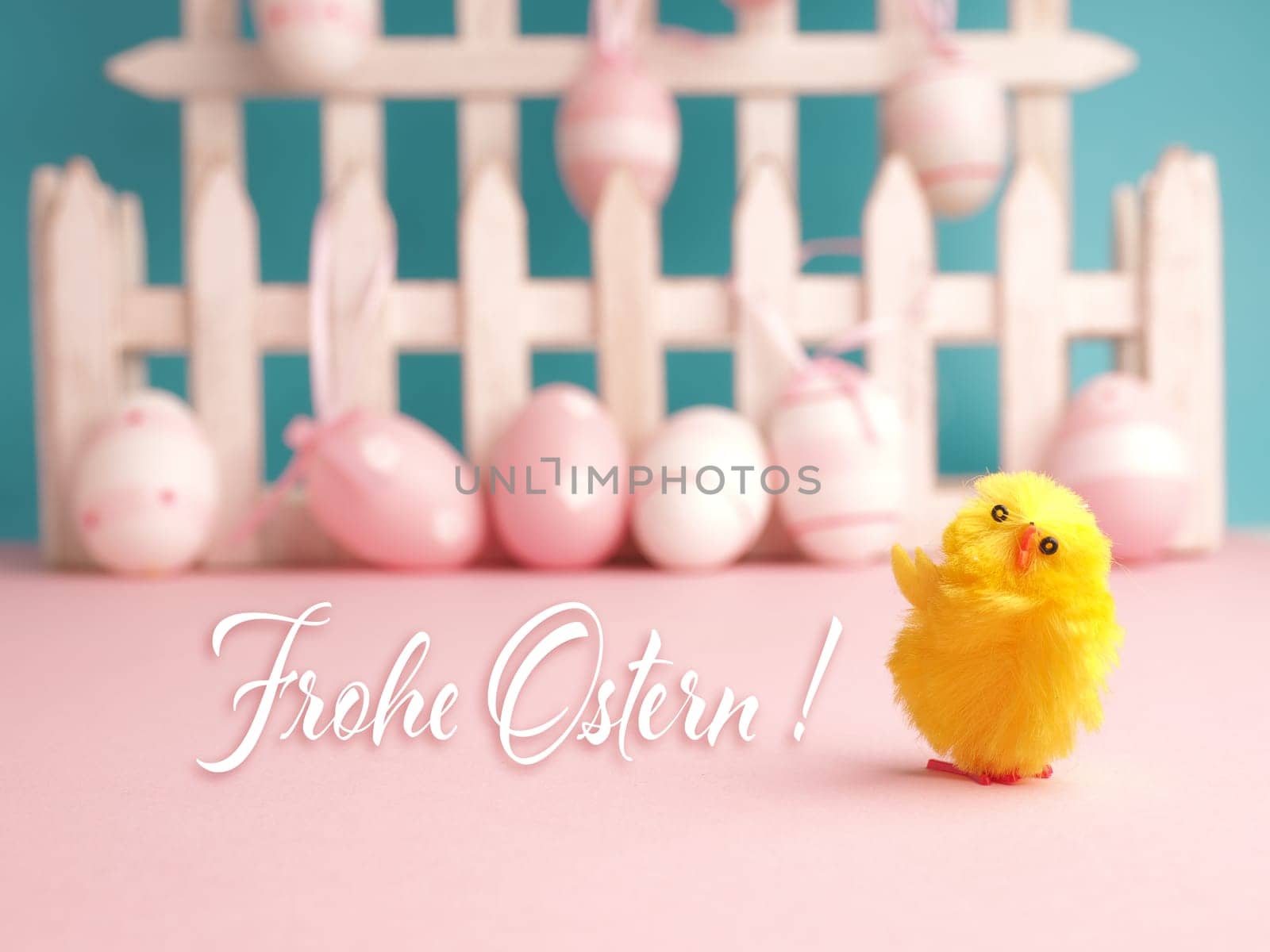 Close up of a cute chick with the German words Happy Easter and an Easter egg background