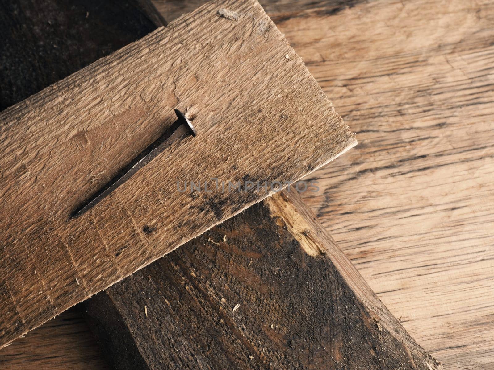 Wooden cross with an old rusty nail symbolizes the crucifixion of Jesus. Easter concept with text free space