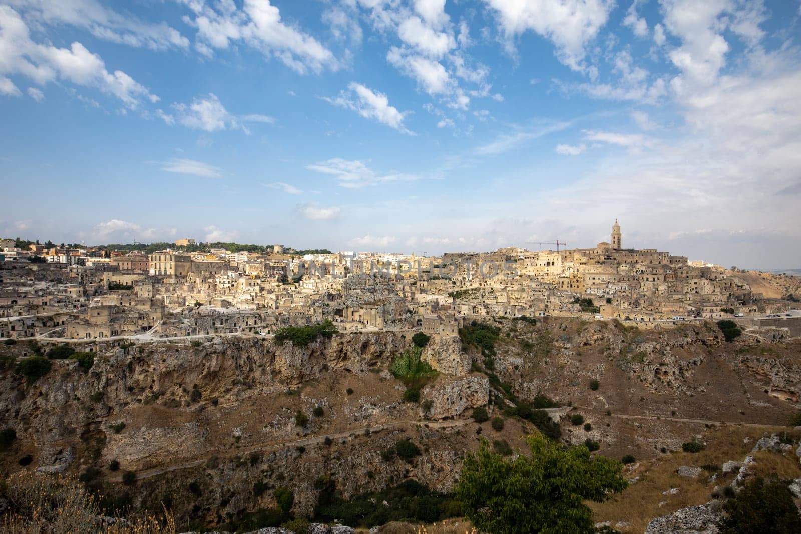 Panoramic view of Sassi di Matera a historic district in the city of Matera, well-known for their ancient cave dwellings from the Belvedere di Murgia Timone,  Basilicata, Italy