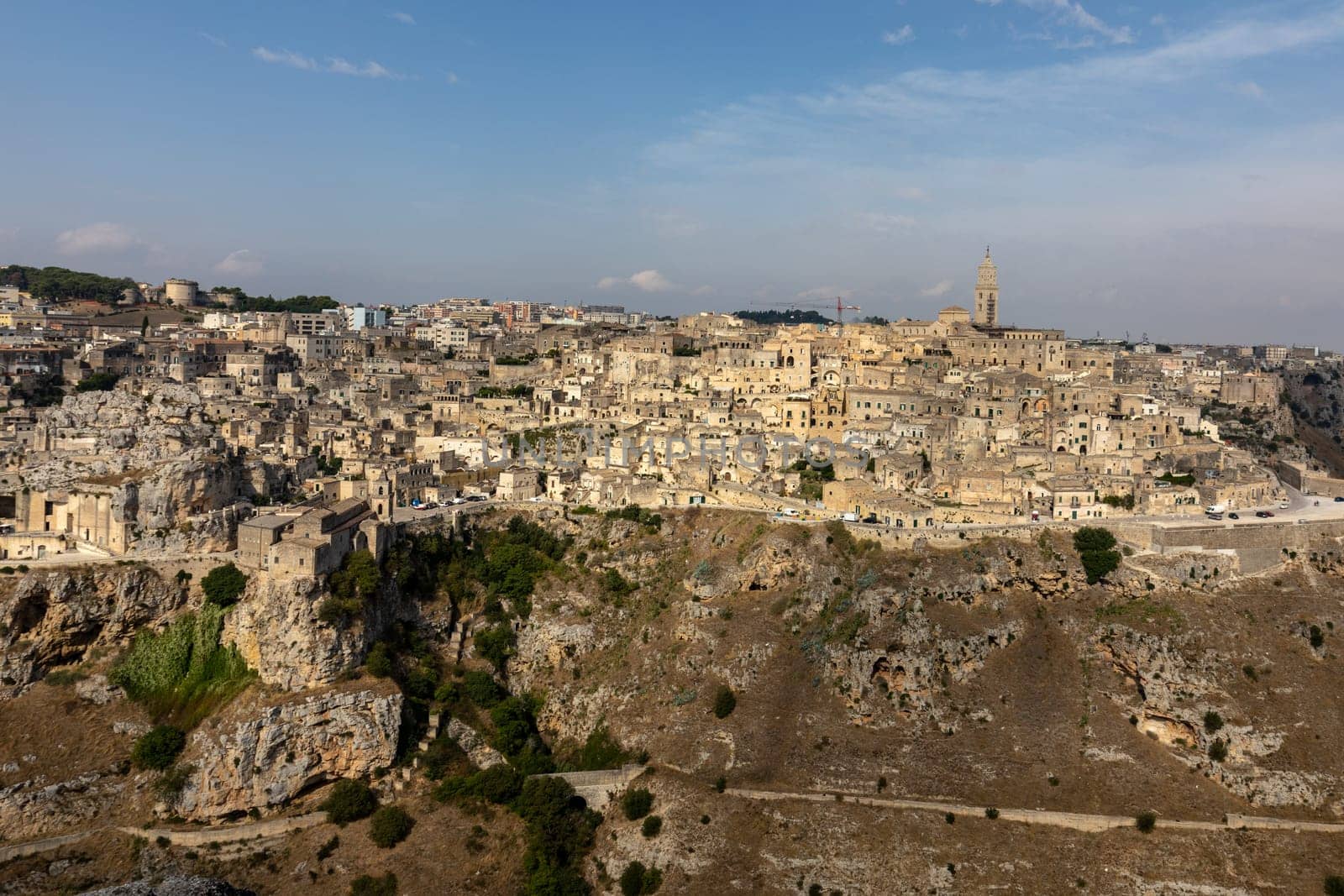 Panoramic view of Sassi di Matera a historic district in the city of Matera, well-known for their ancient cave dwellings from the Belvedere di Murgia Timone,  Basilicata, Italy