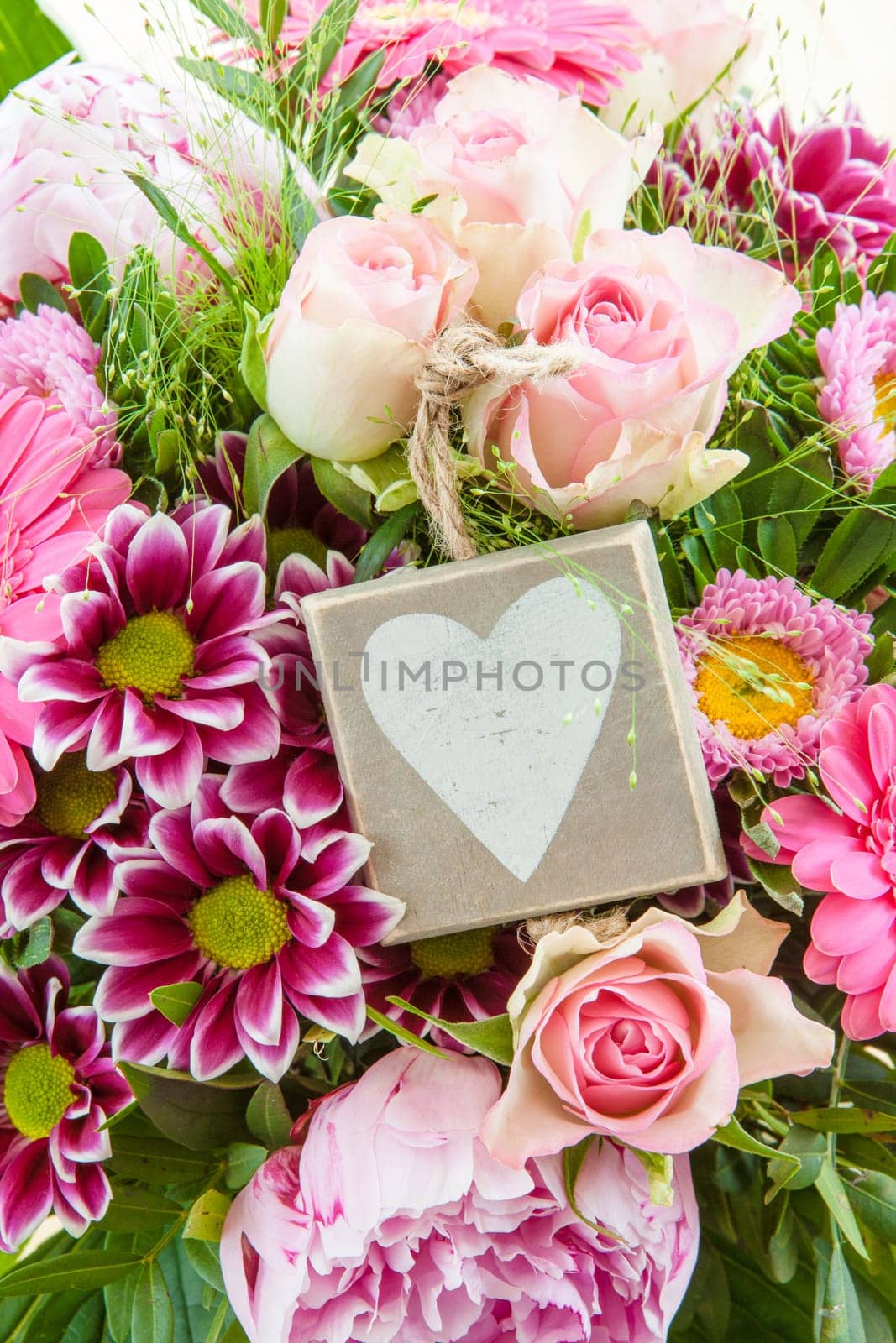 Colorful summer flowers in a bouquet with gift-awepers
