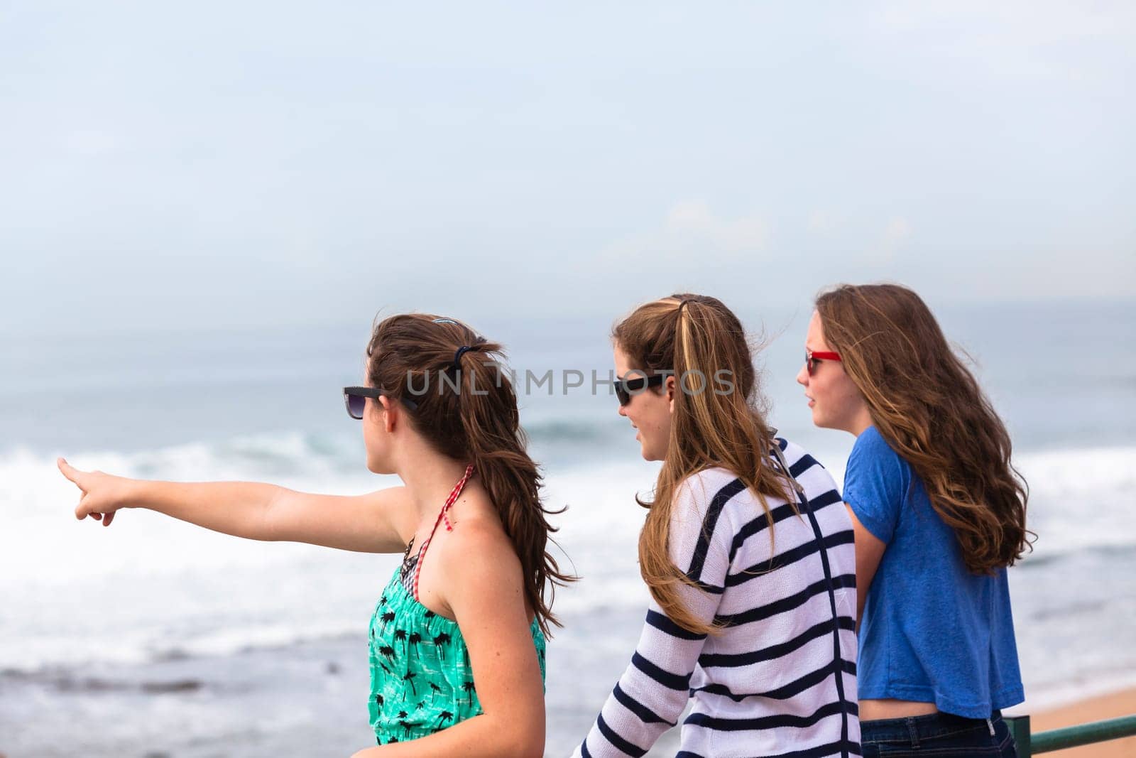 Teenagers girls at beach holidays talk laughter swimming sea ocean waves