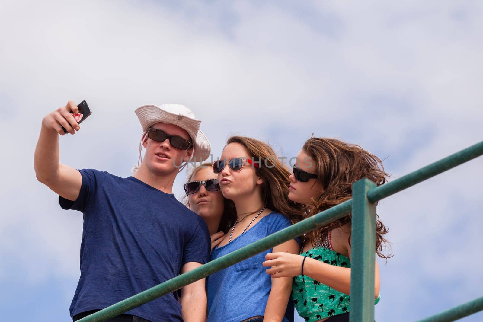 Teenagers at beach holidays talk laughter swimming sea ocean waves